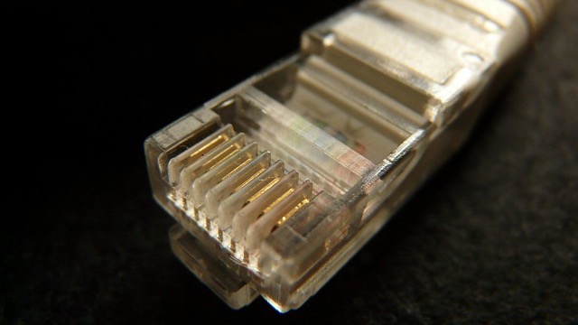 LightReading tech logo, minimal design on gray background, broadband infrastructure funding theme.