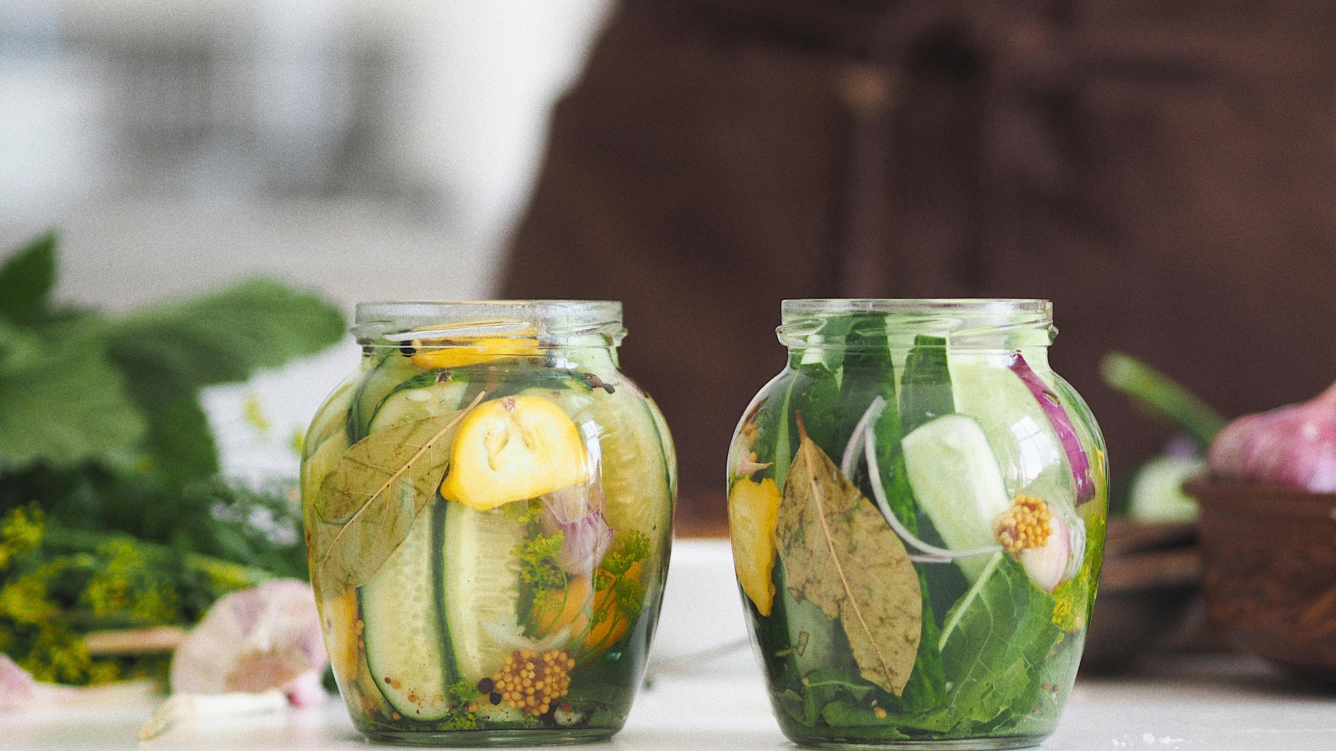 San Antonio farmers market vendor displays pickles with a smile.