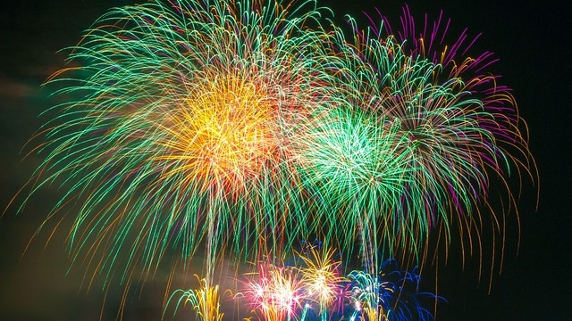 Vibrant San Antonio arts event with musician on stage and large crowd.