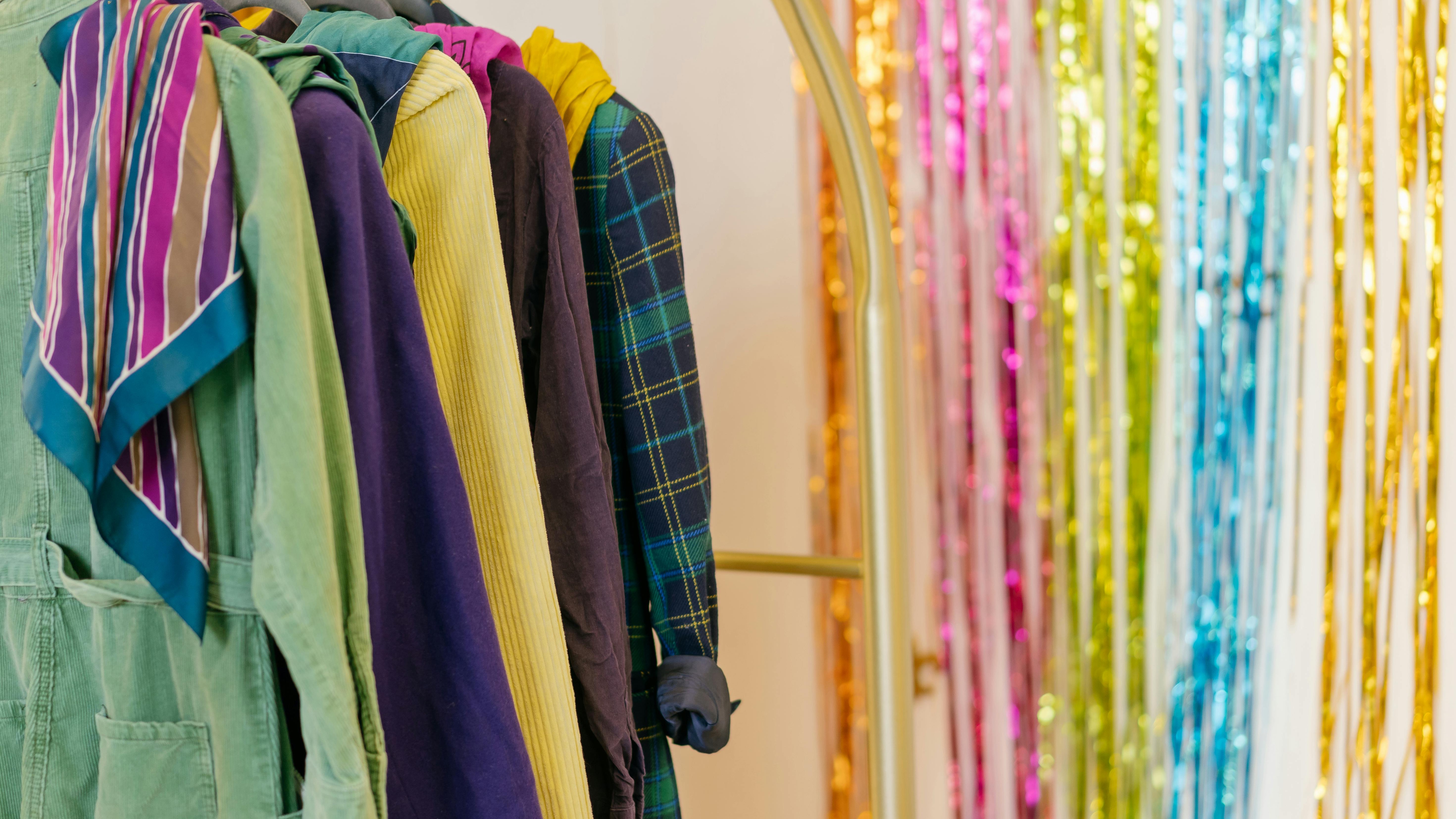 Young woman wearing custom wool chore coat, minimal setting.