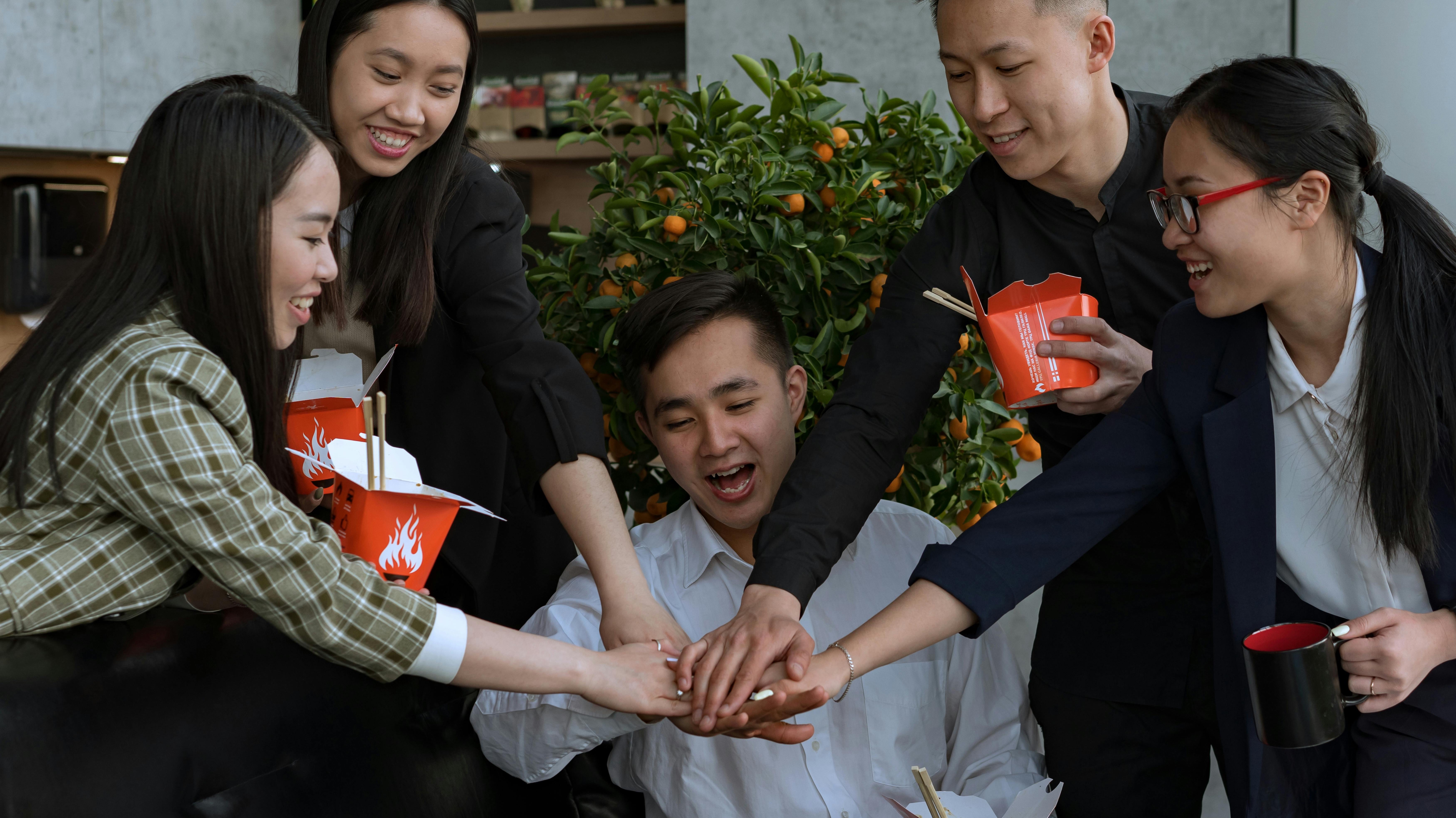 Hands holding puzzle pieces, symbolizing teamwork to combat employee burnout.