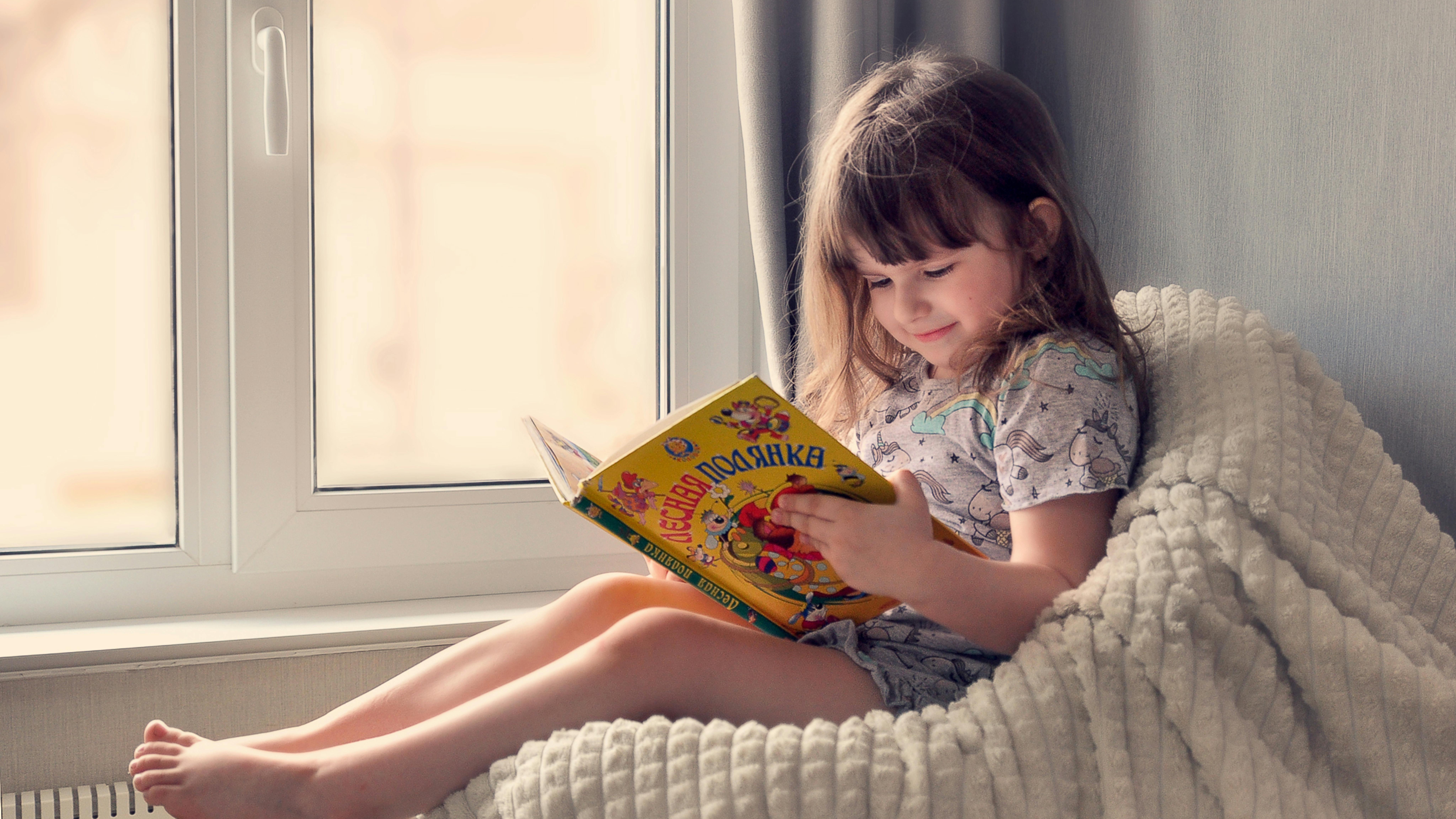 Young boy focused on reading to improve comprehension skills.