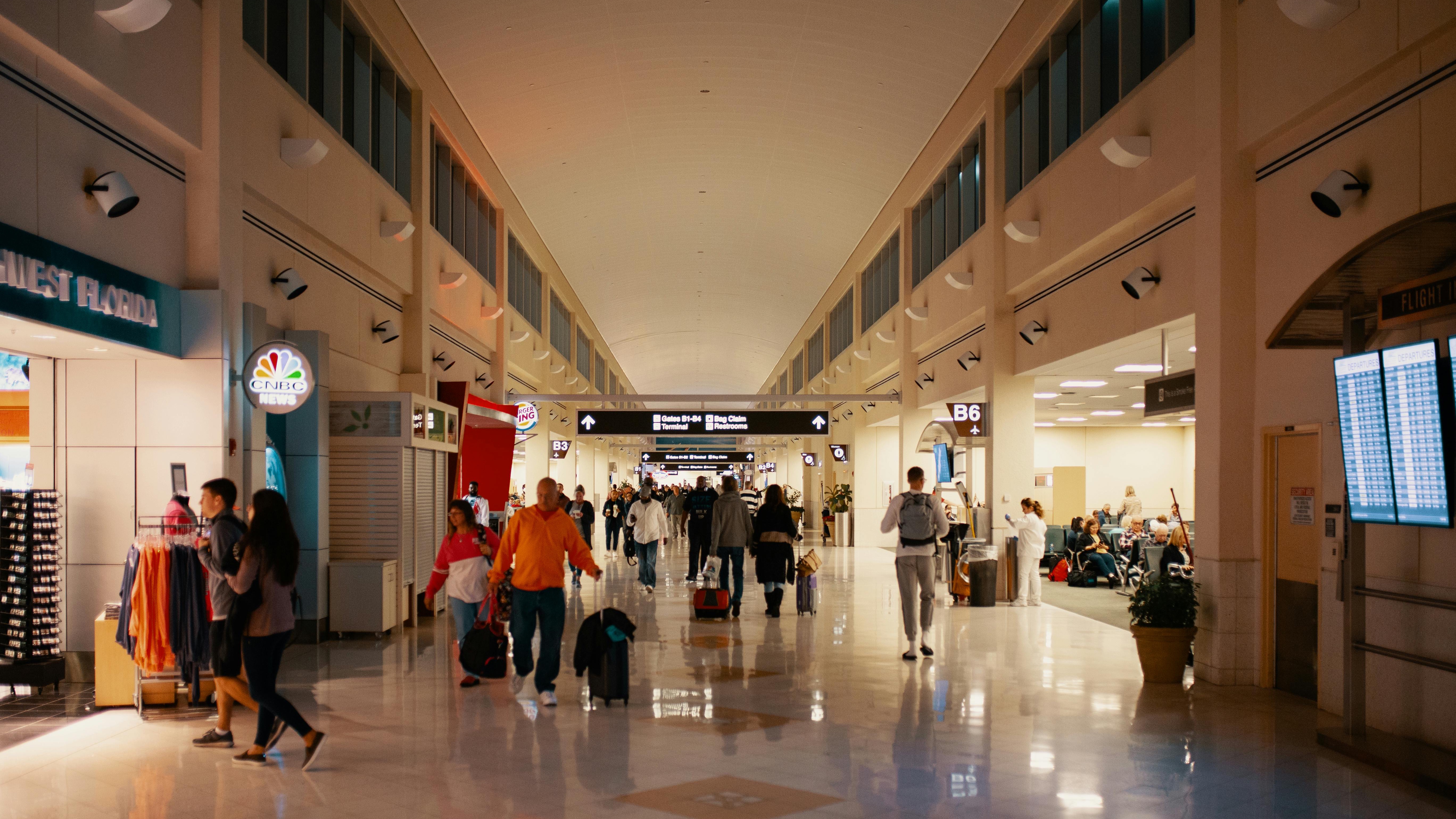 Travelers endure long TSA wait times at a busy airport terminal.