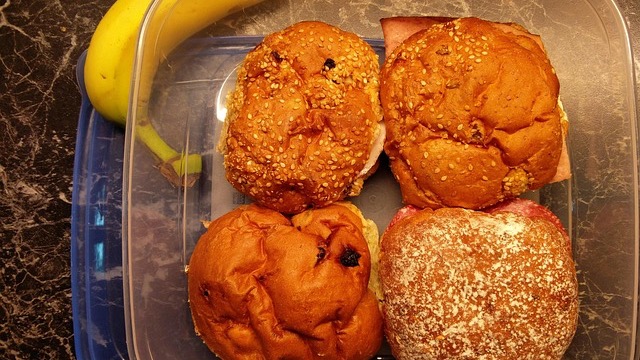 Joyful child making smoothies with mother in a cozy kitchen.