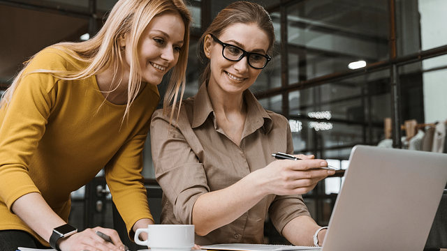 Smiling man with glasses in a street scene, phrases HR needs to abandon.