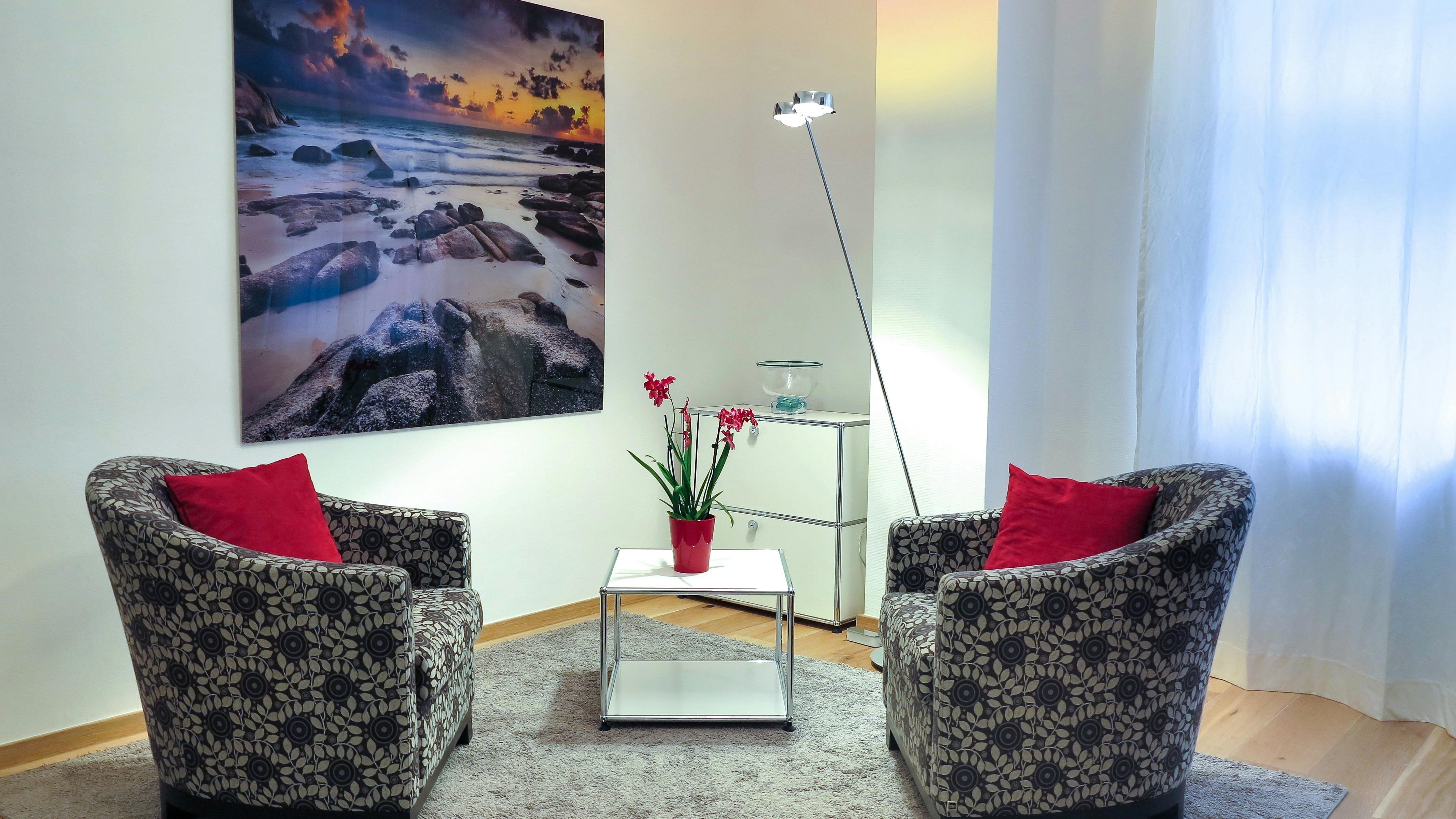 Nature-inspired living room decor with green plants and leafy prints.