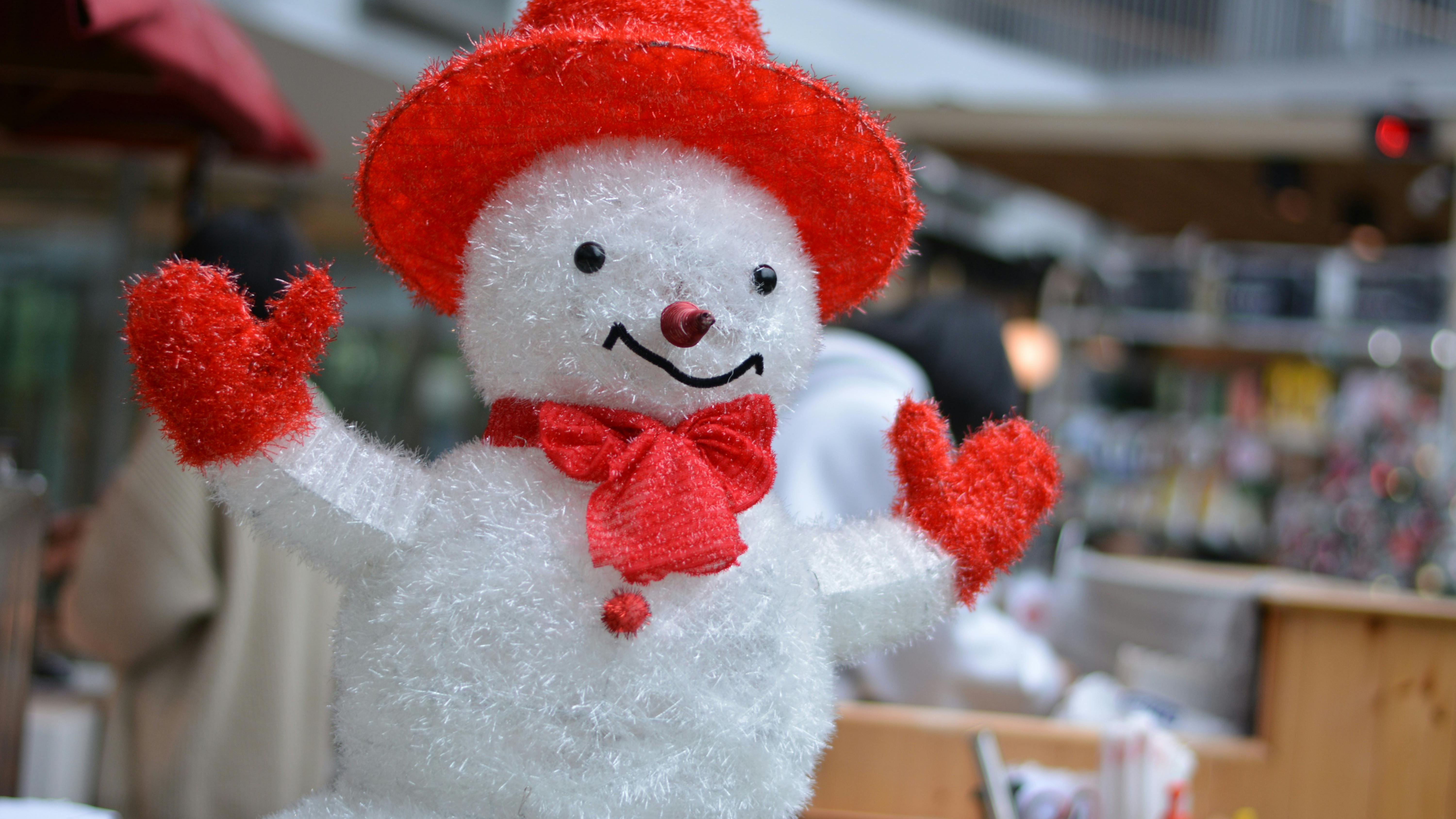 Person making snowball at Omaha events this week, winter scene.
