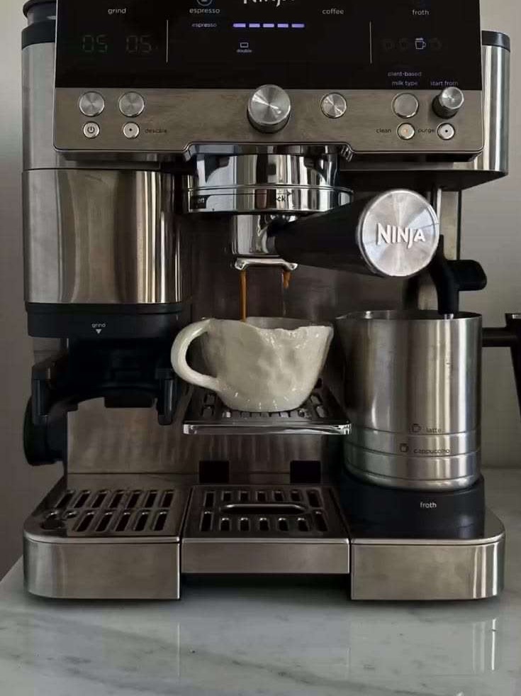 Smart home devices showcased in a modern kitchen with coffee machines.