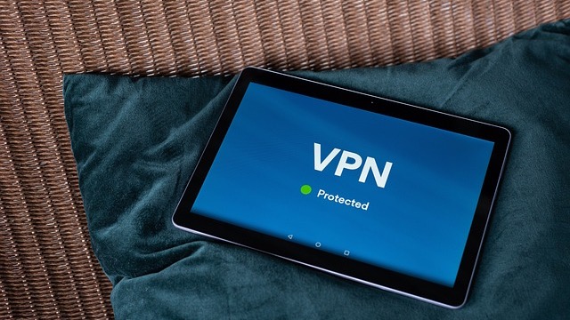 Smartphones displaying VPN shield icons against blue background, best VPN for 2026.