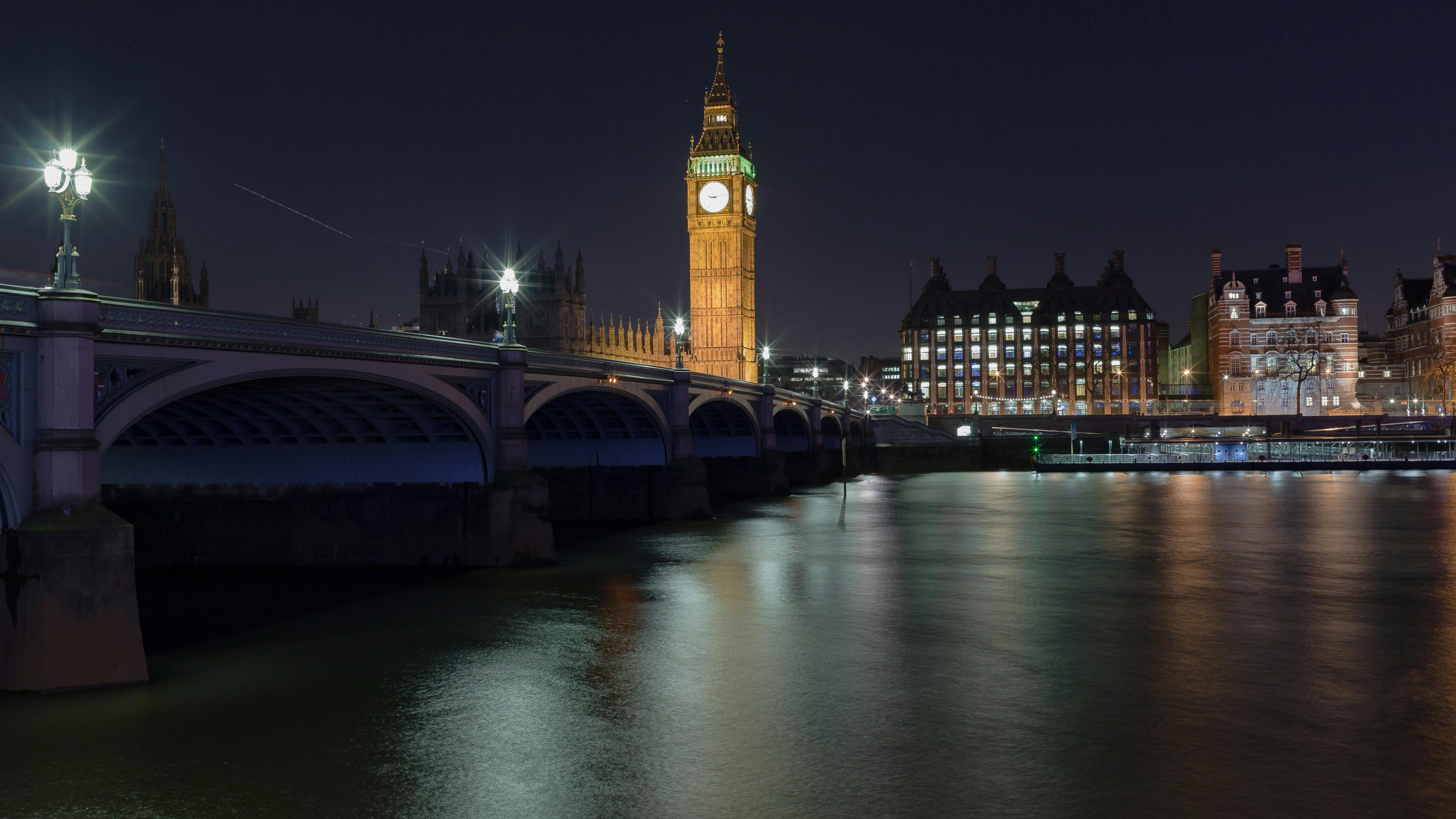 Reflective glass building with apple logo related to broadband infrastructure funding.