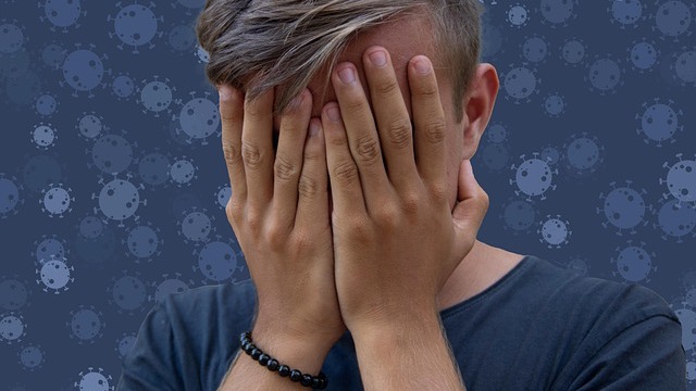 Teenager in hoodie sitting by window, conveying emotions, teenage communication.