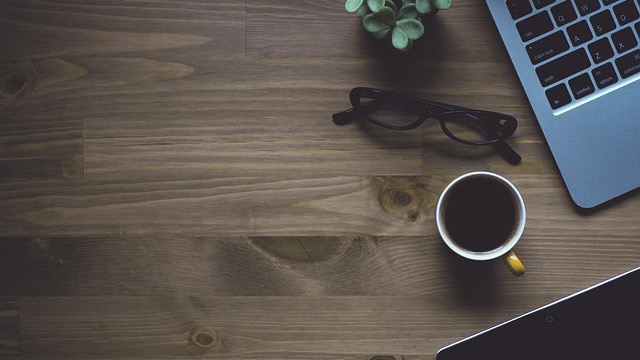 Inviting entryway with plush stool and abstract mirror leading to a bright kitchen.