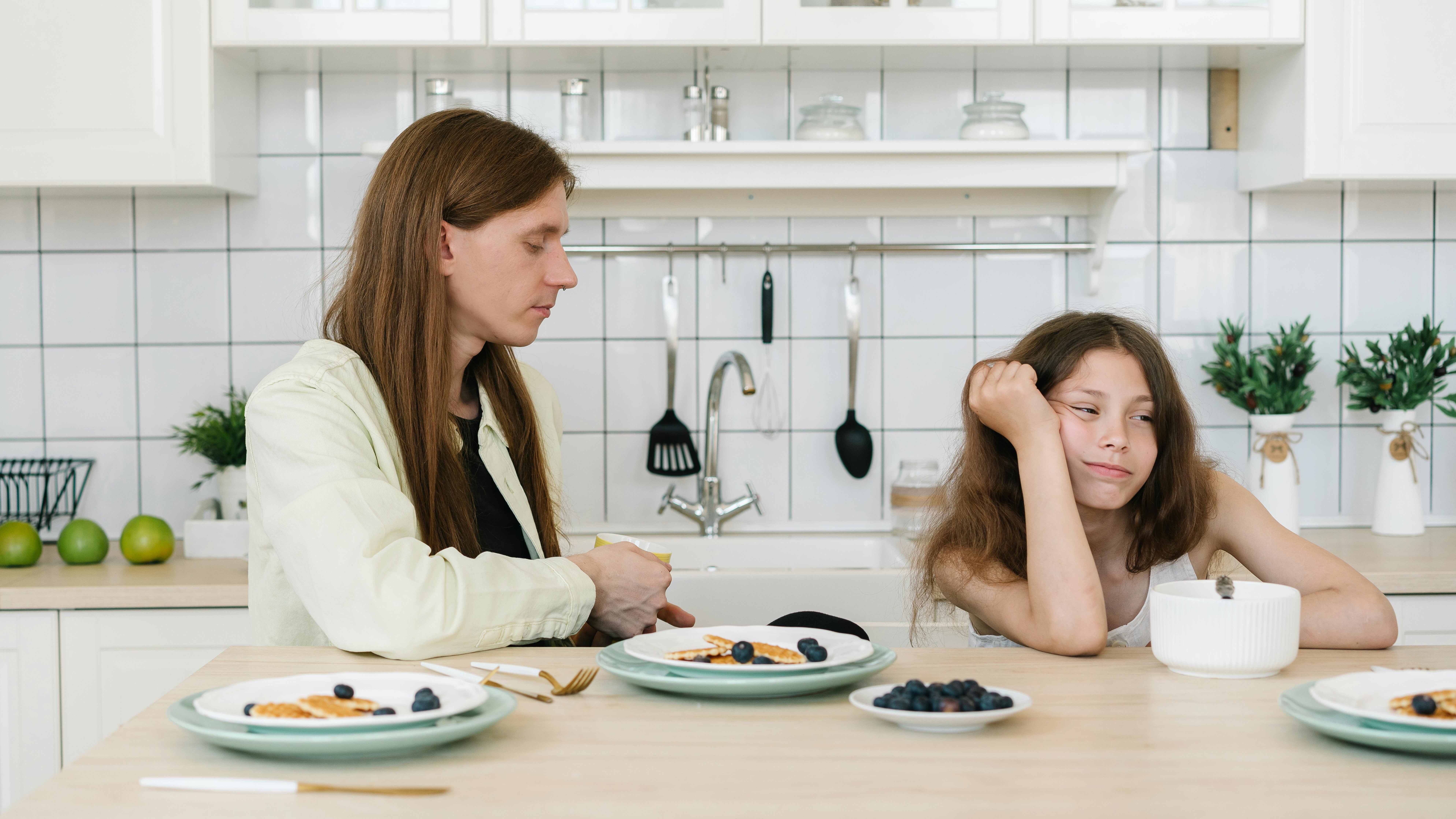 Stressed parent experiencing parental burnout with children in messy room.