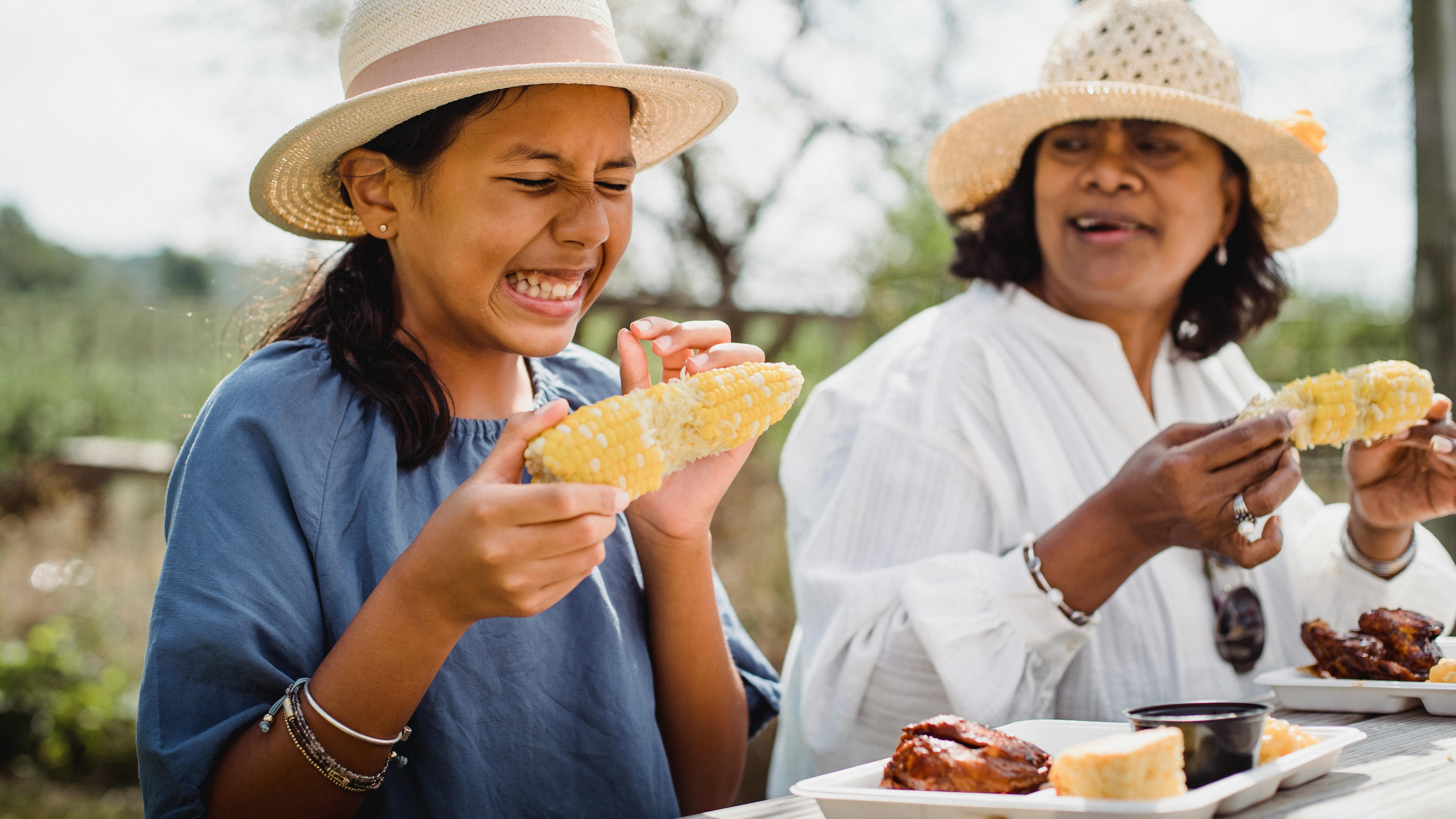 Two people enjoying pizza, a solution for picky eaters.