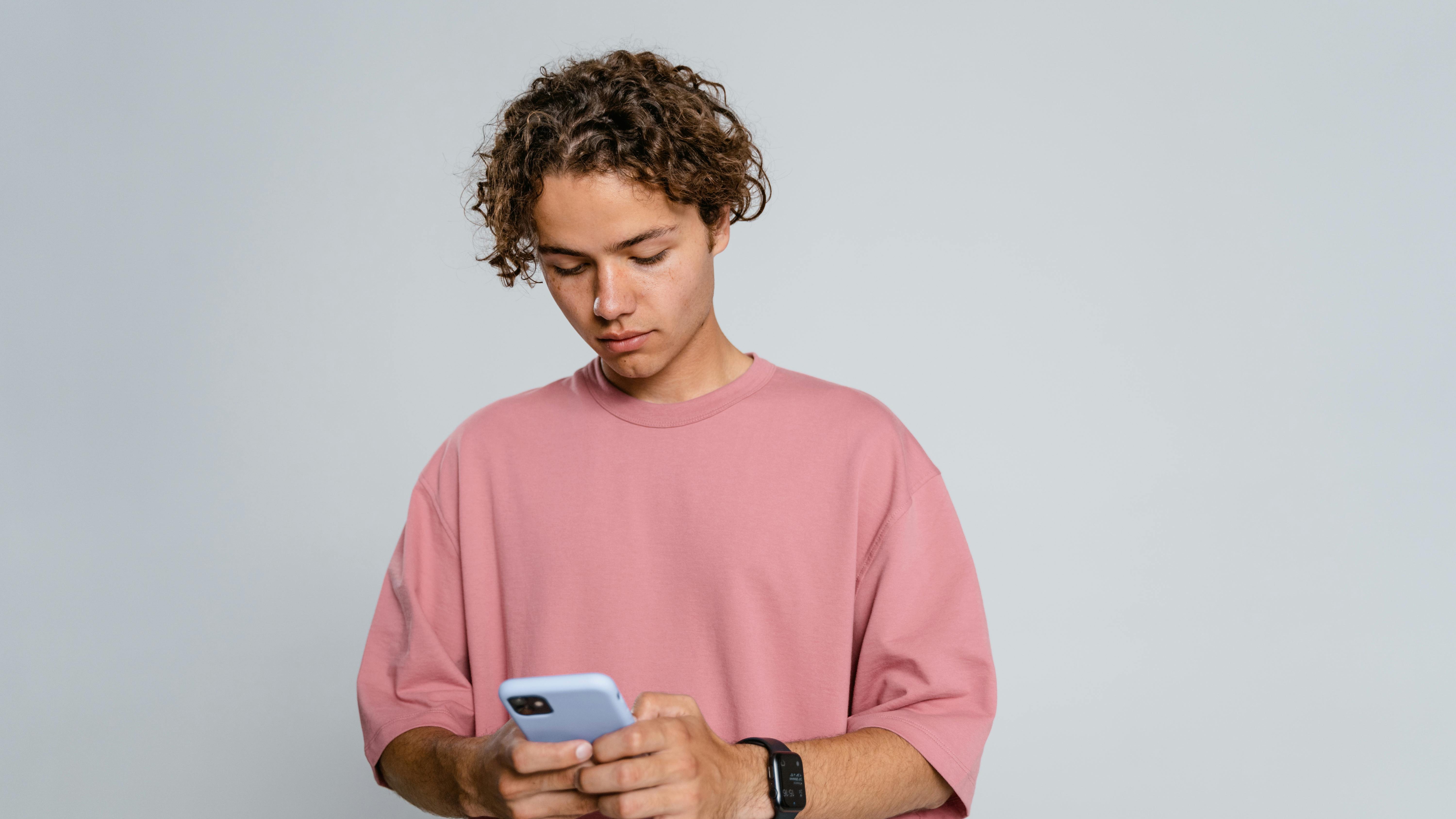 Teenage girl using smartphone for communication in a city setting.