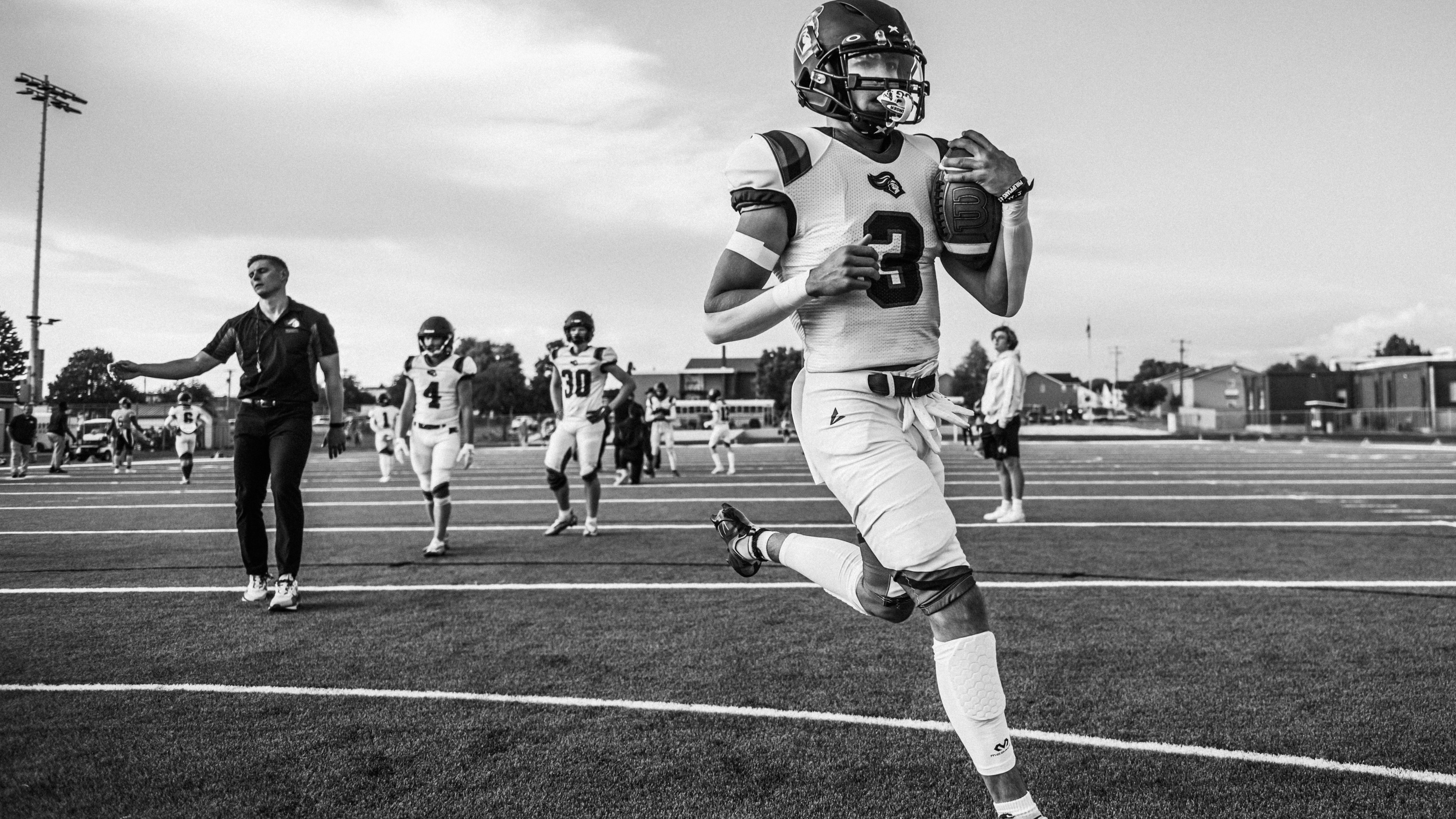Fans wearing masks hold funny sign at sports event.