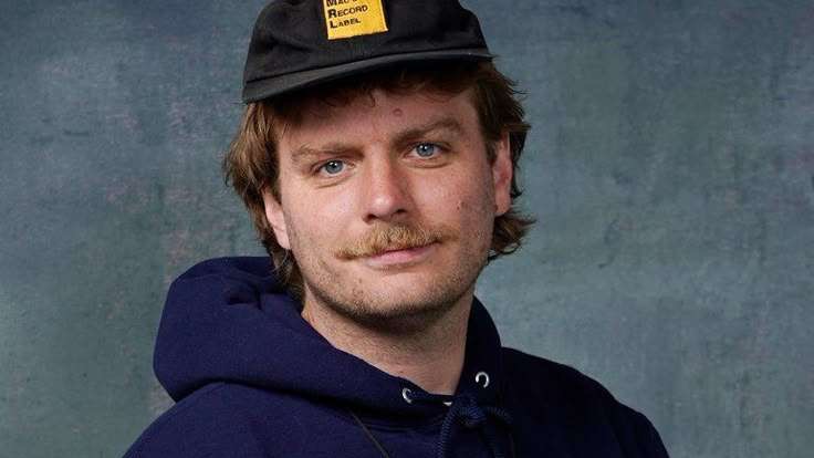 Mac DeMarco concert in Omaha with vibrant stage lights and performers.