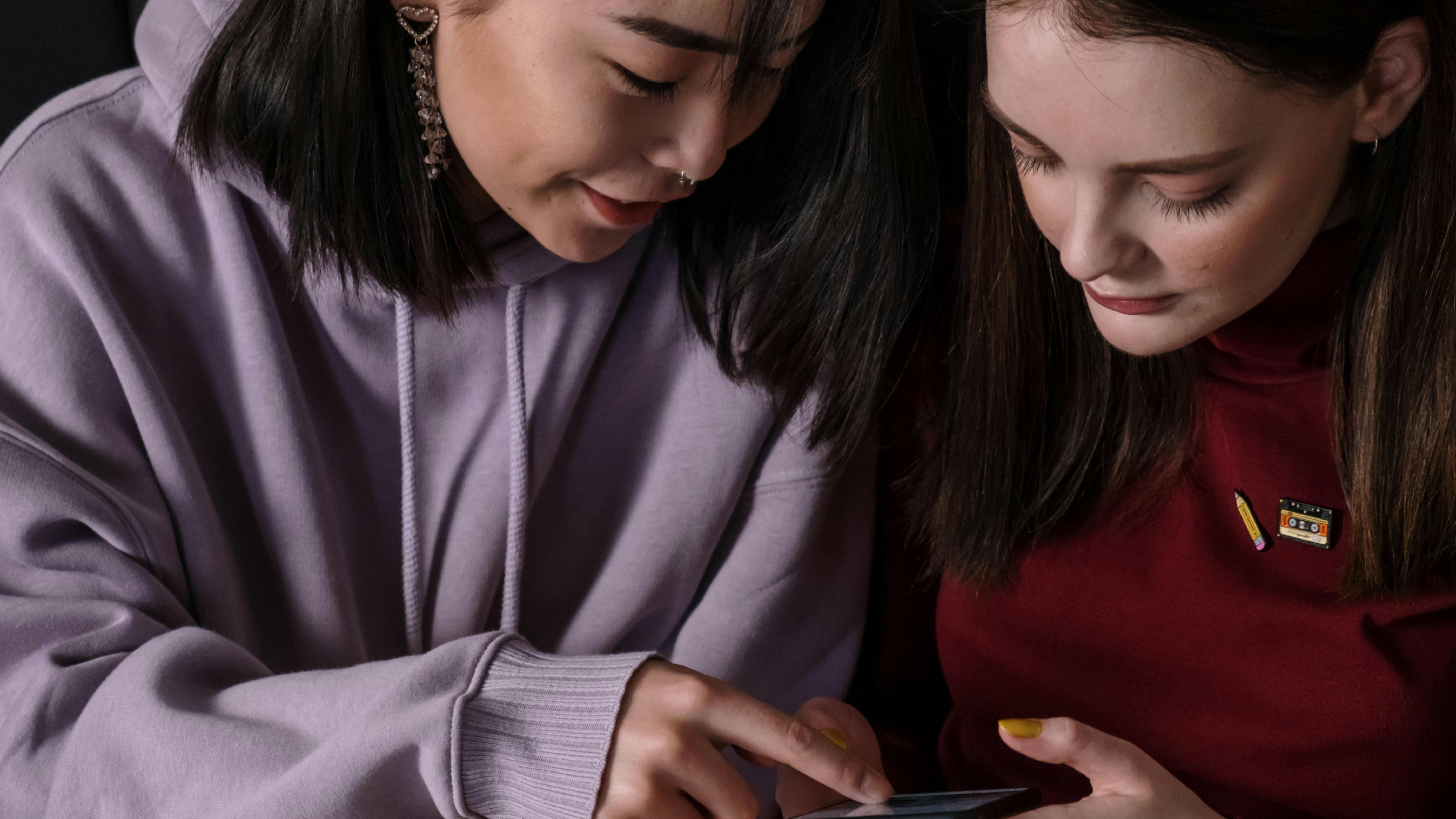 Contemplative young woman gazing out the window, teenage communication.