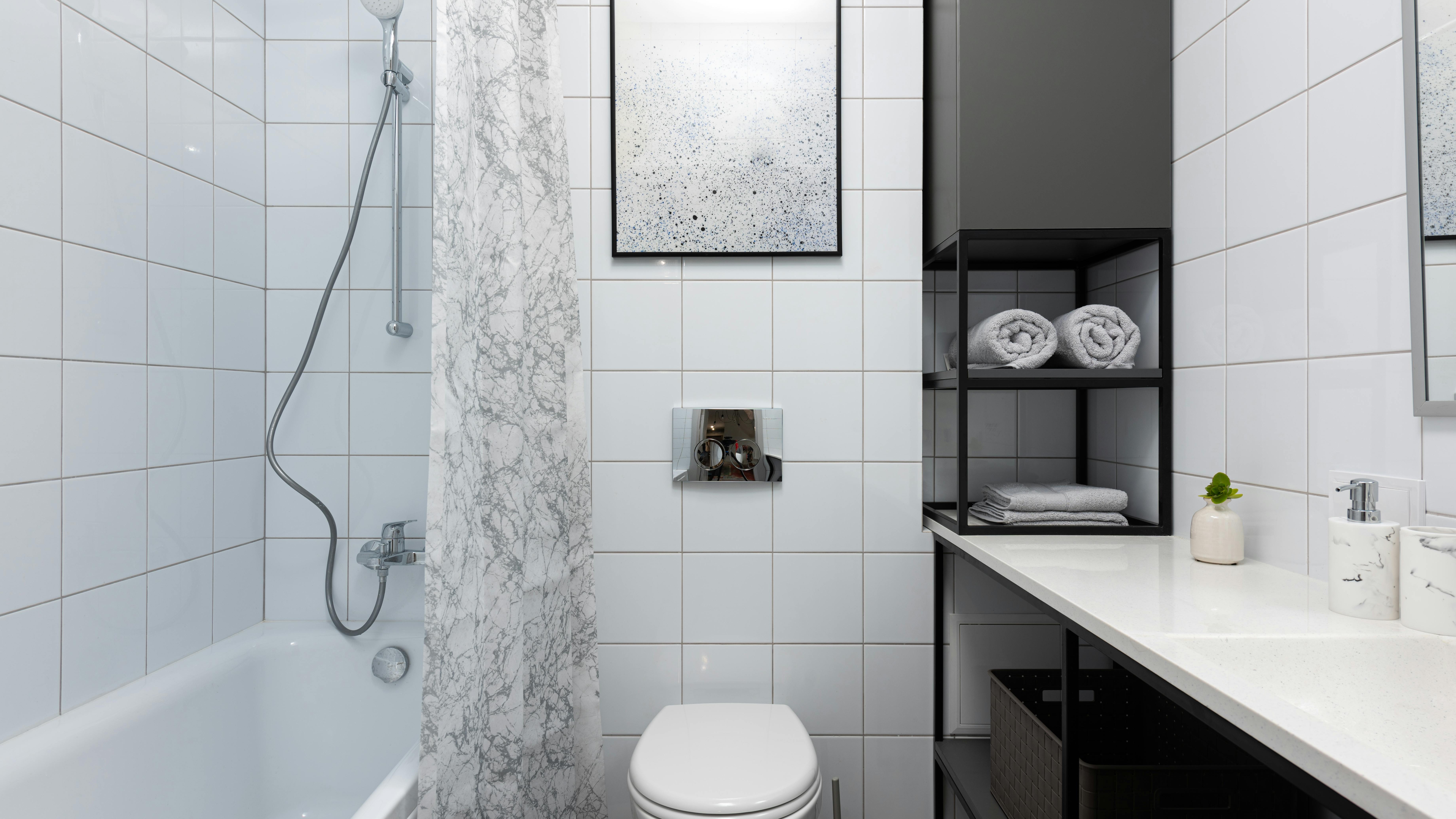 Modern smart bathroom with digital shower and tiles, sleek design.