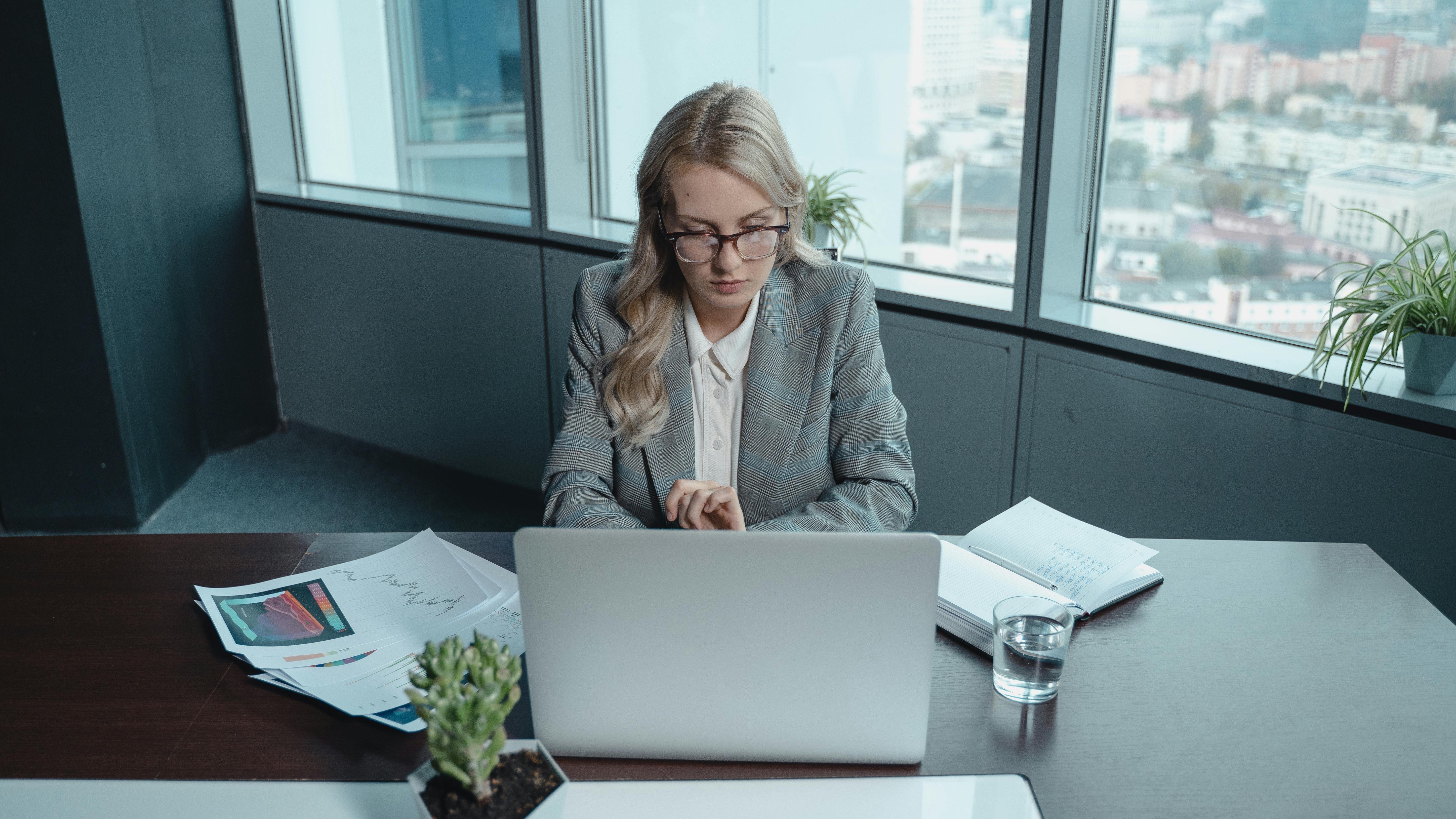 Professional woman pondering the gender wage gap in a modern office.