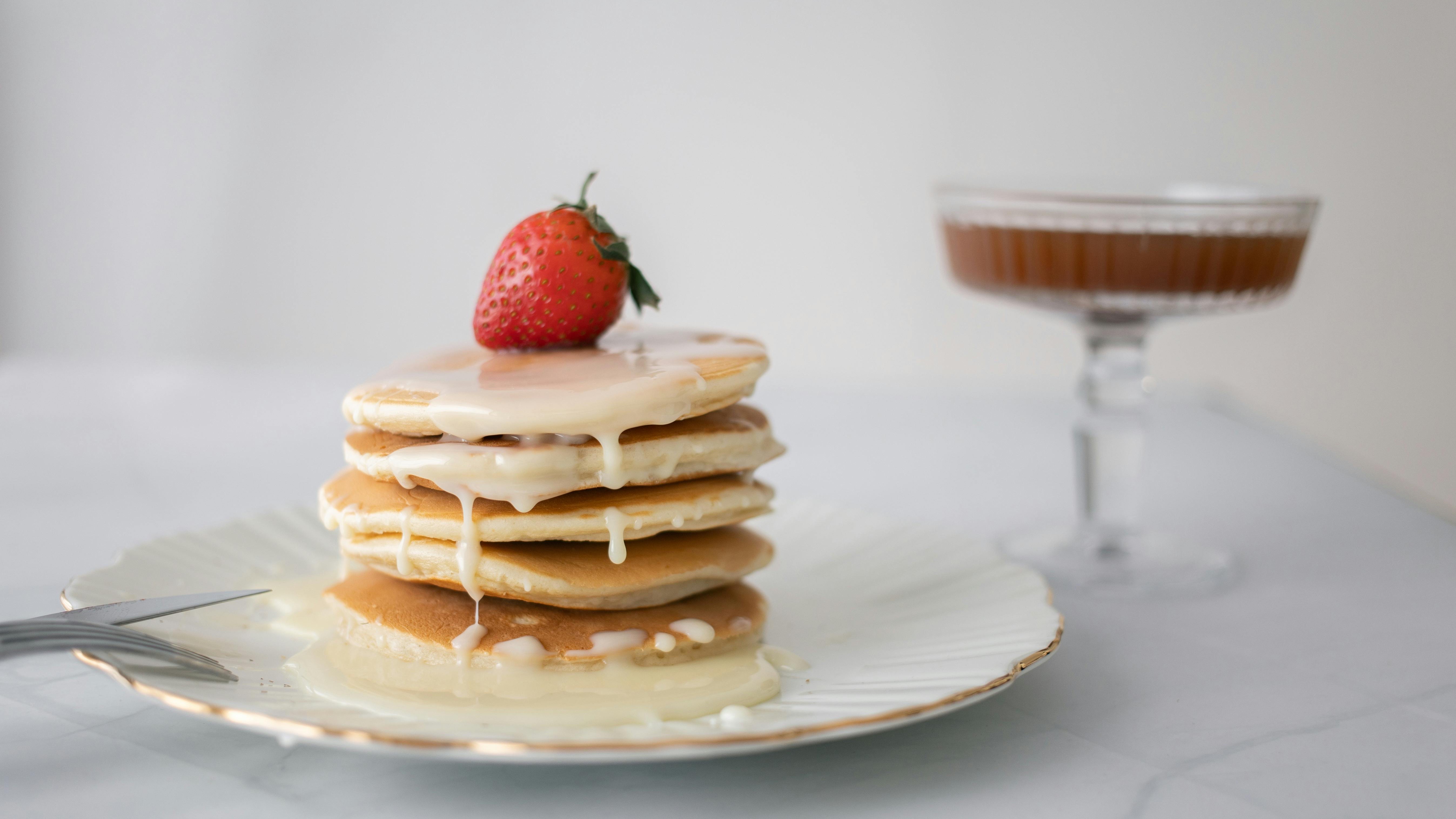 Healthy family meals with colorful pancakes and fruits.