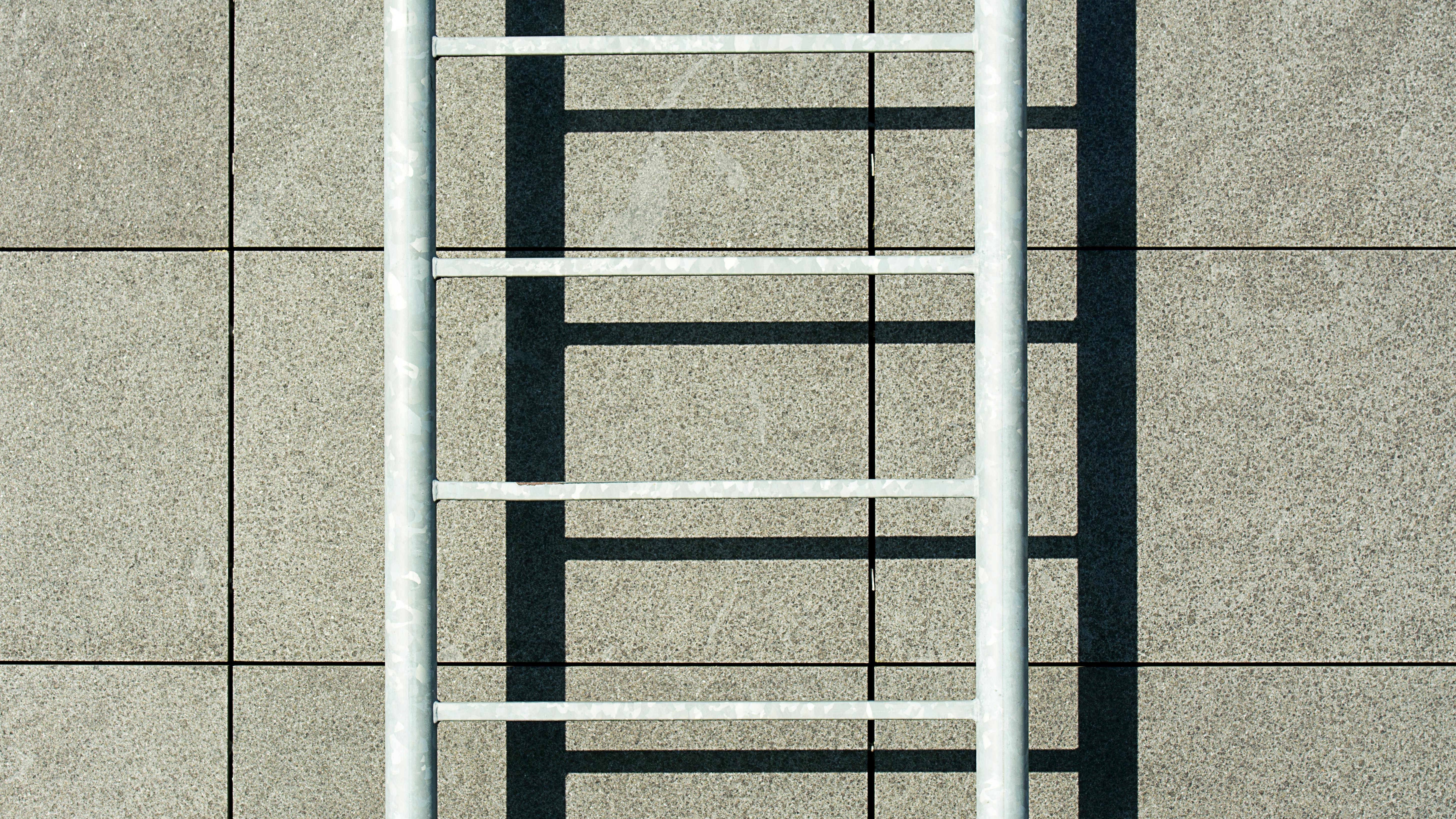 Man ascending ladder, symbolizing traditional career ladder.