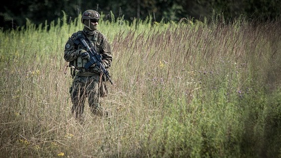 Soldiers equipped with the Army's new rifle and machine gun in forest