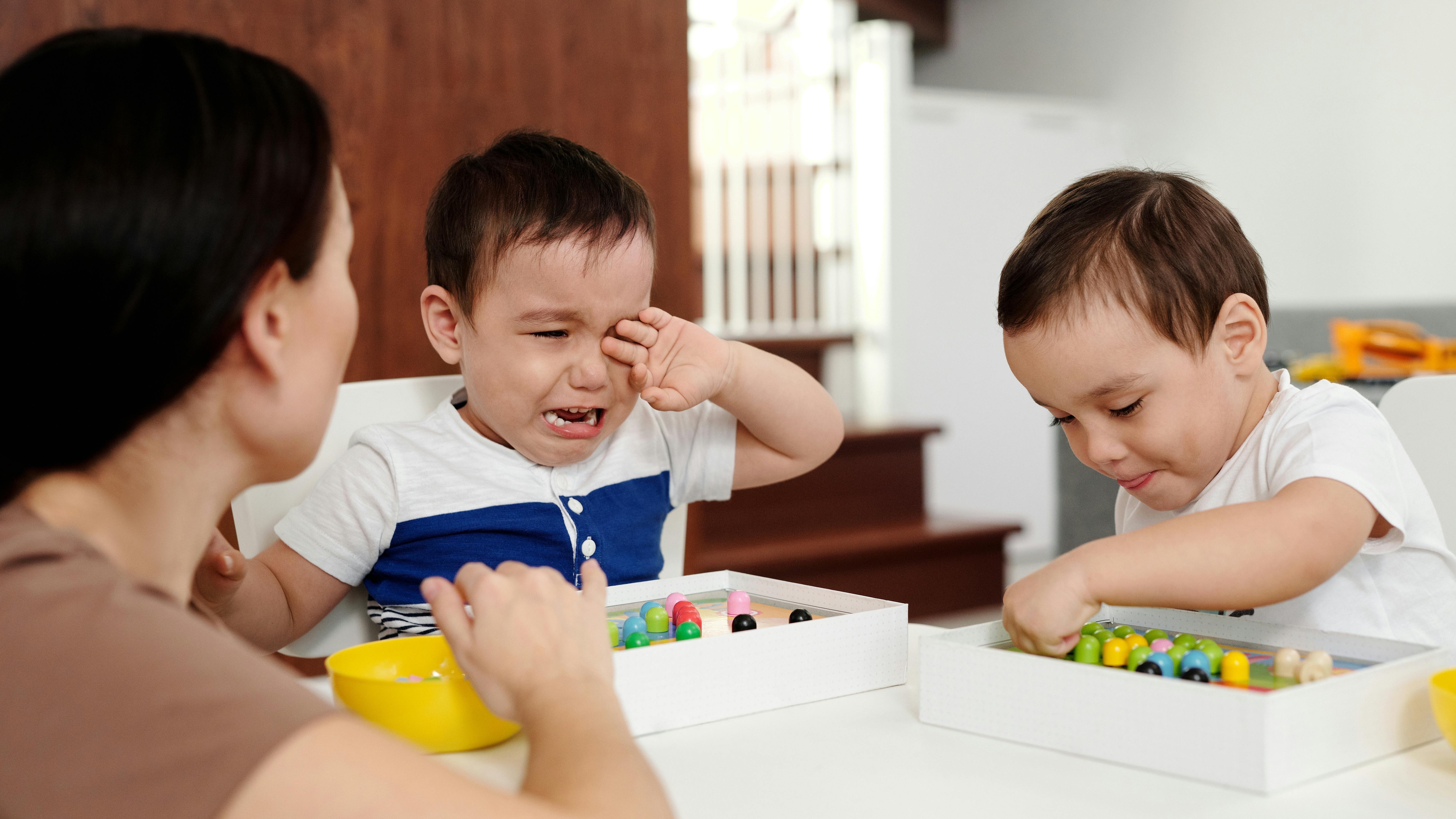 Energetic child showing excitement in a cozy living room.