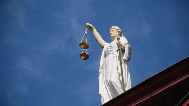 Non-Judicial Punishment Leadership concept with balance scale.