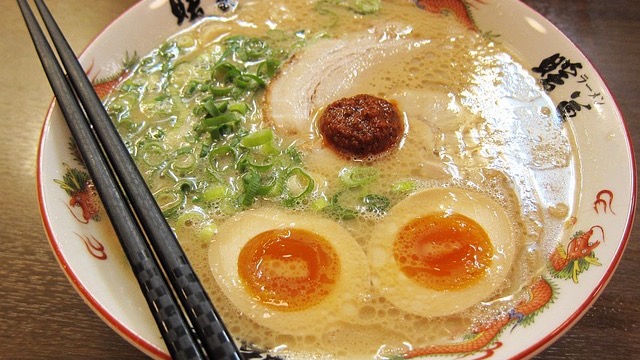 Friendly couple in Omaha ramen shop with vibrant decor