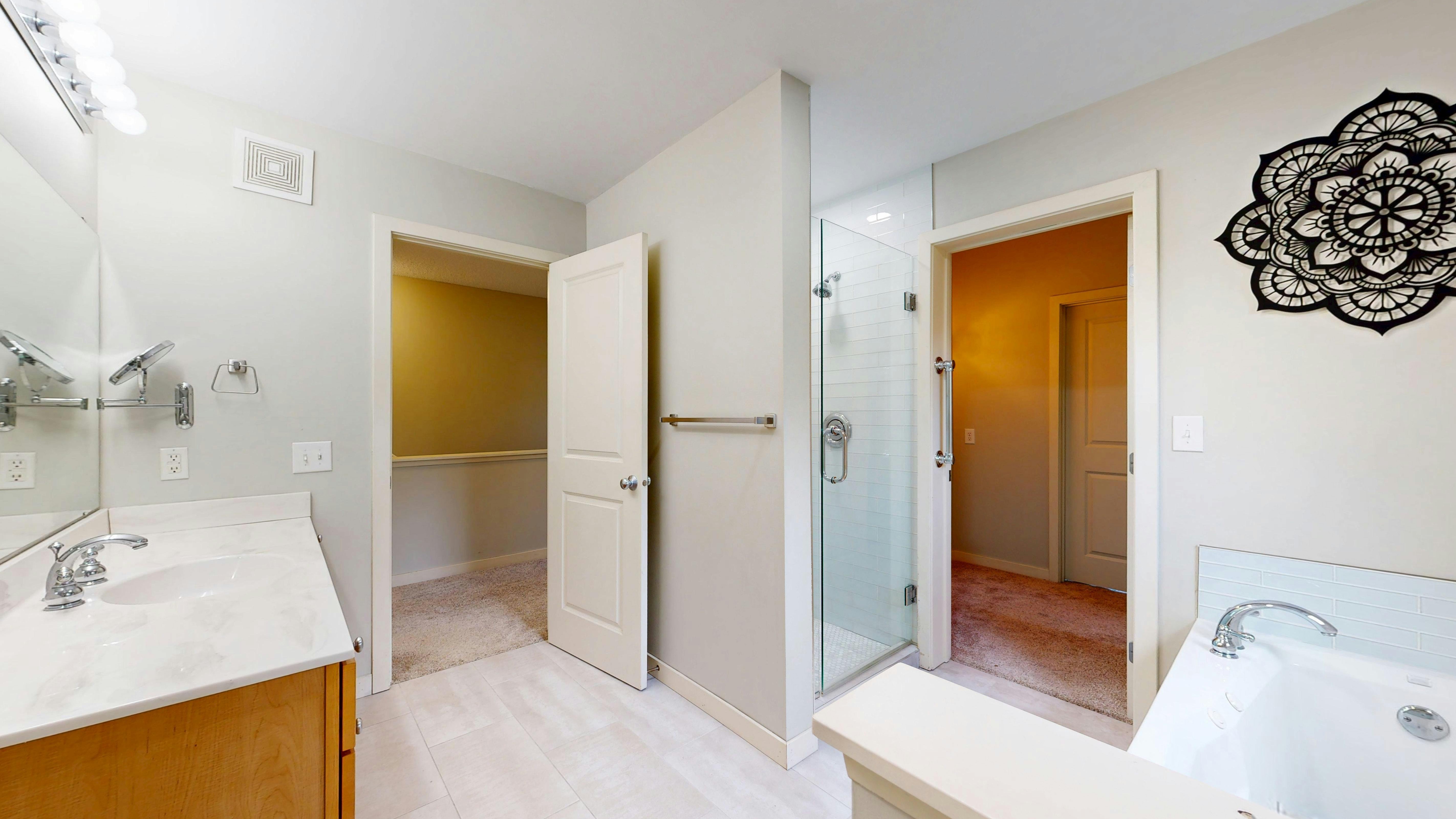 Luxurious bathroom with a freestanding tub and mountain view, modern design.