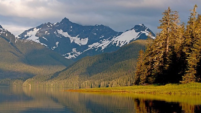 Boat near Alaska coastline for fiber optic cable service.
