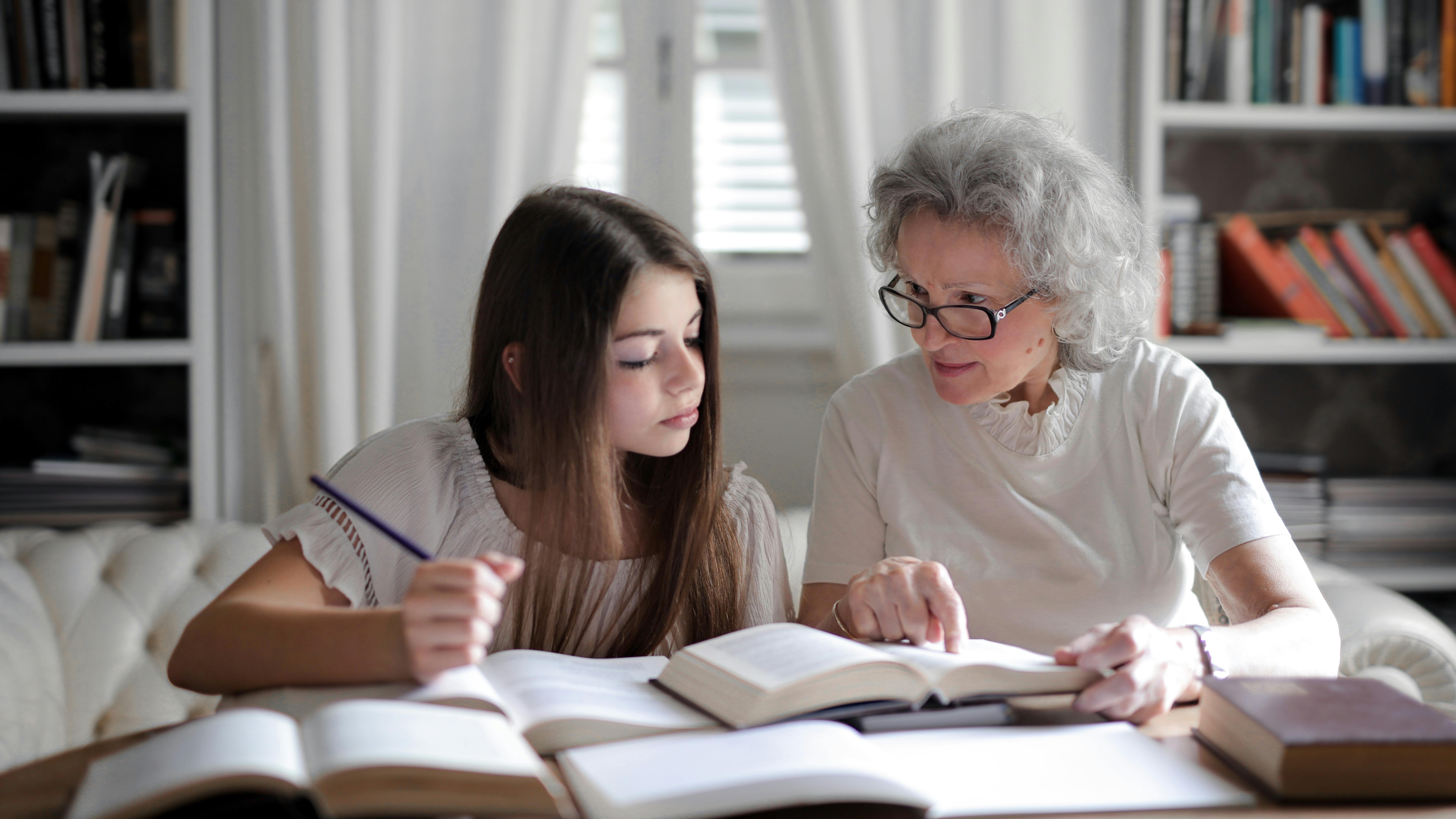 Smiling teenage girl communicating in a classroom setting.