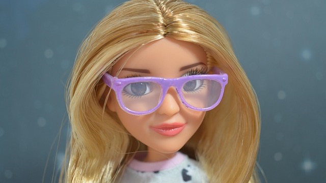 Futuristic laptop displays AI avatars for video creation.