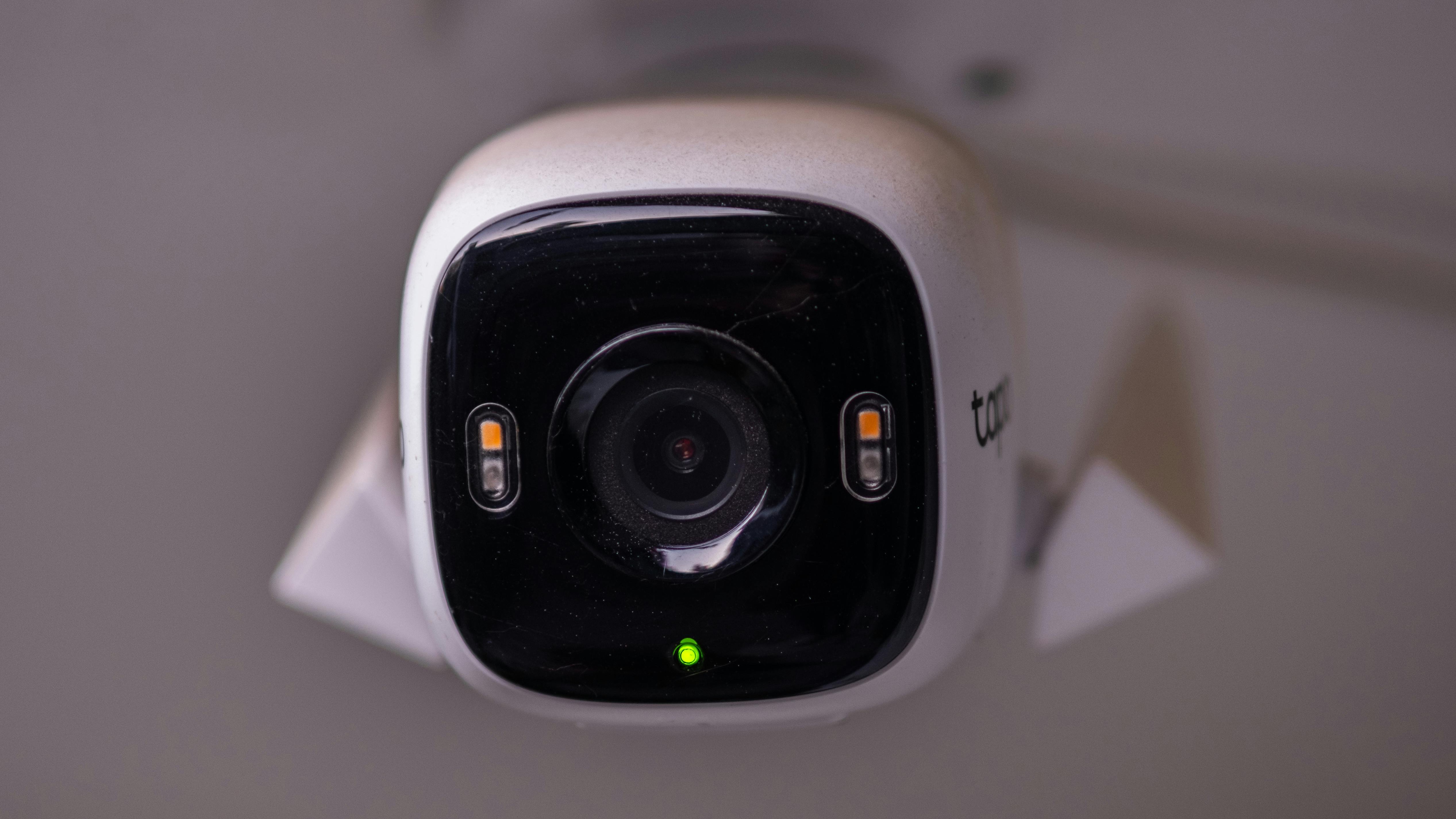 Modern indoor security camera with rabbit design on shelf.