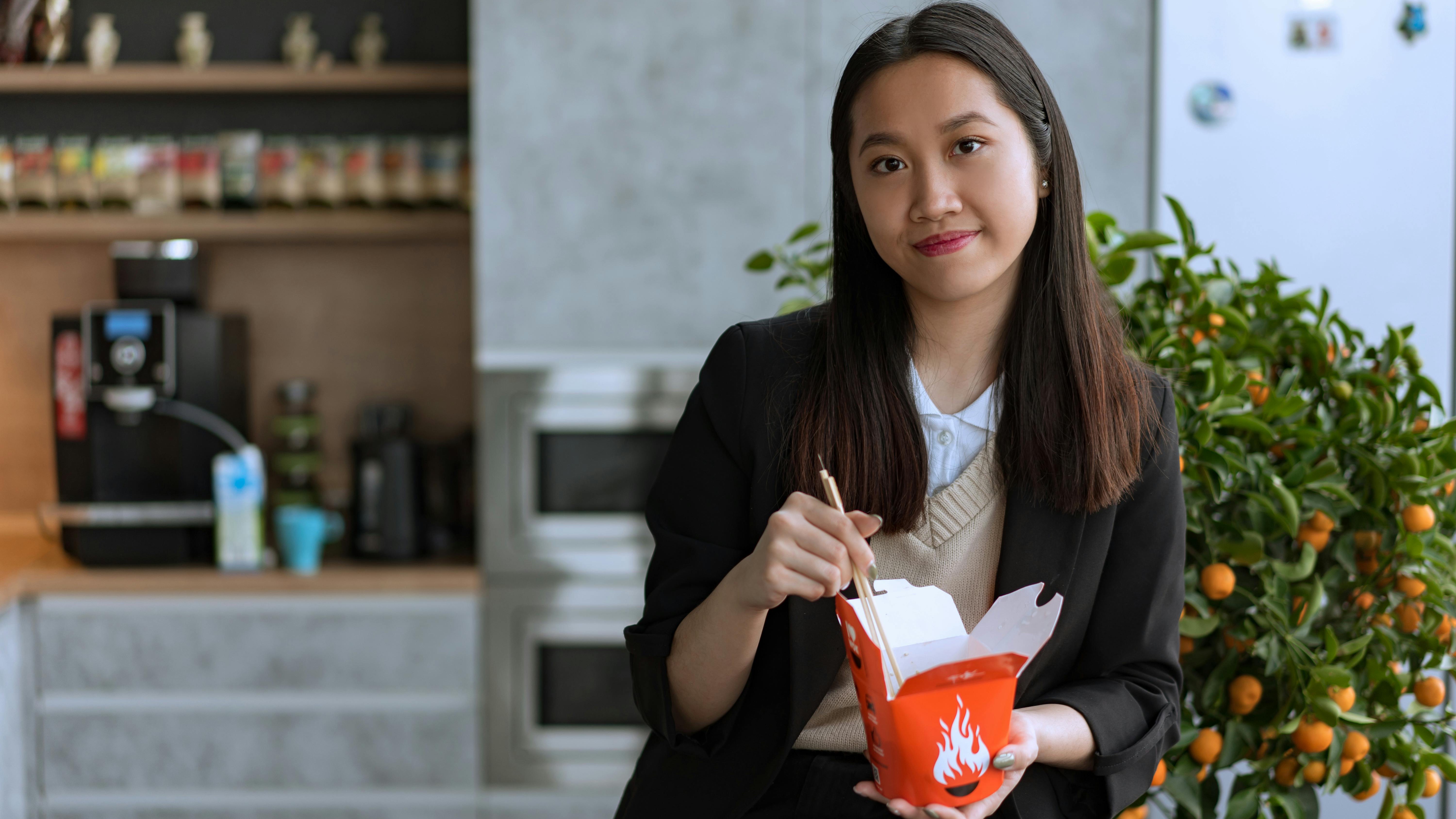 Courthouse building with cars on city street in afternoon light.