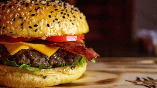 Juicy San Antonio hamburger with jalapeños and fries