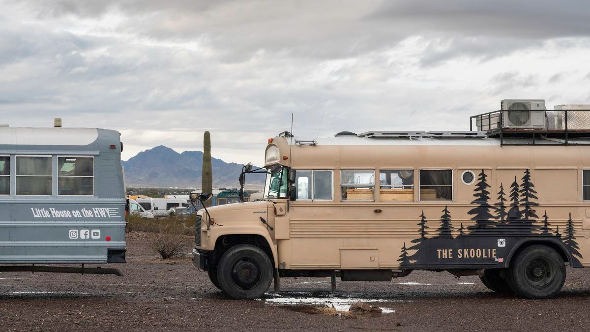 Colorful retrofitted school bus with basketball hoop shot.