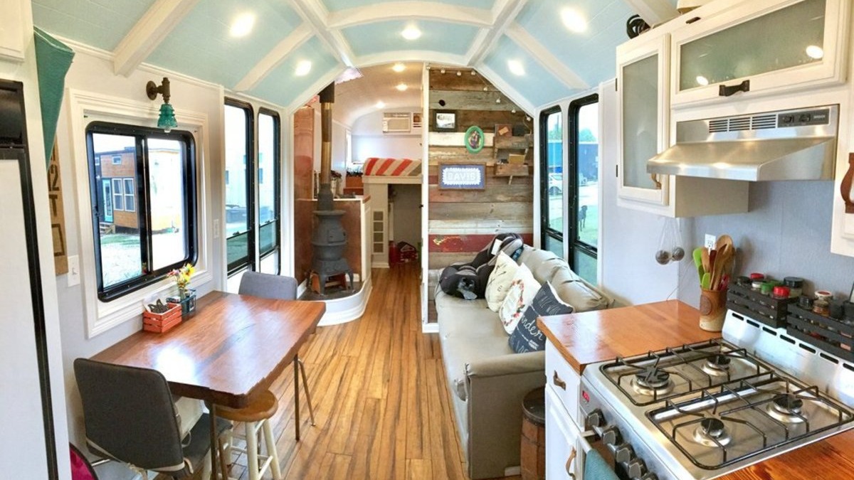 Tiny house ideas: couple with converted bus on beach.