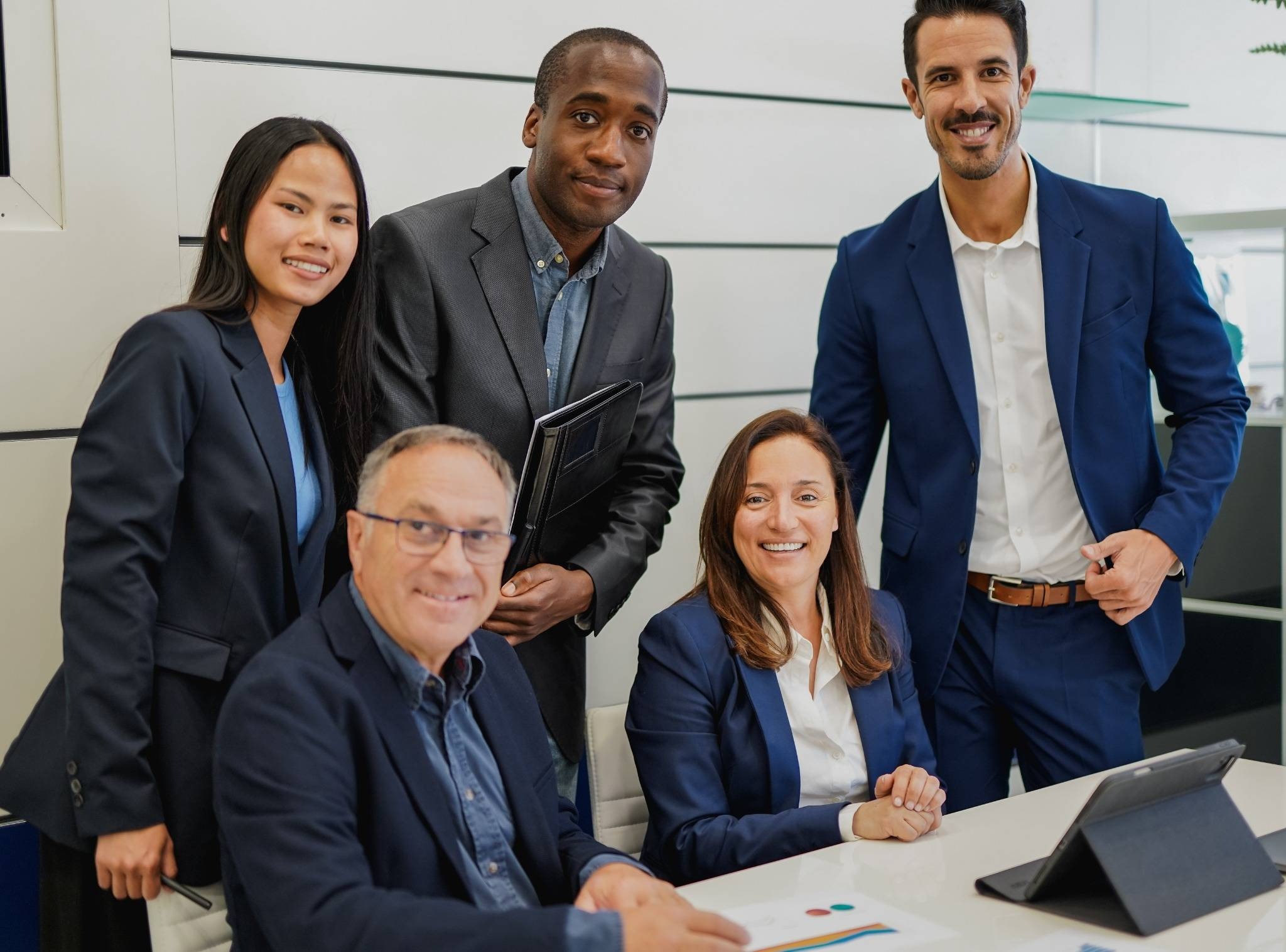 Diverse group working collaboratively in industrial setting, embracing global culture and inclusion.