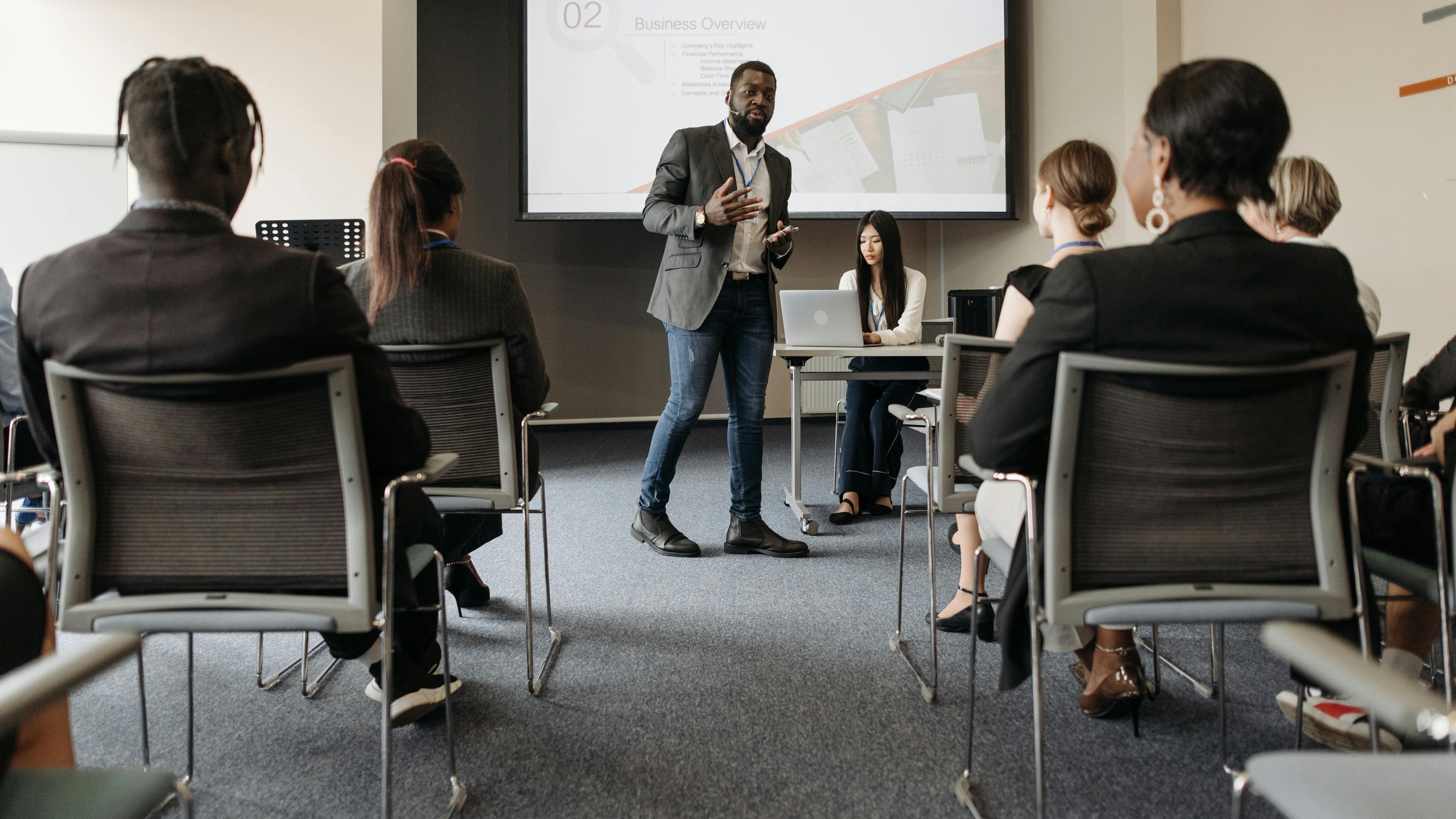 Young workers in a coding workshop discussing training costs.