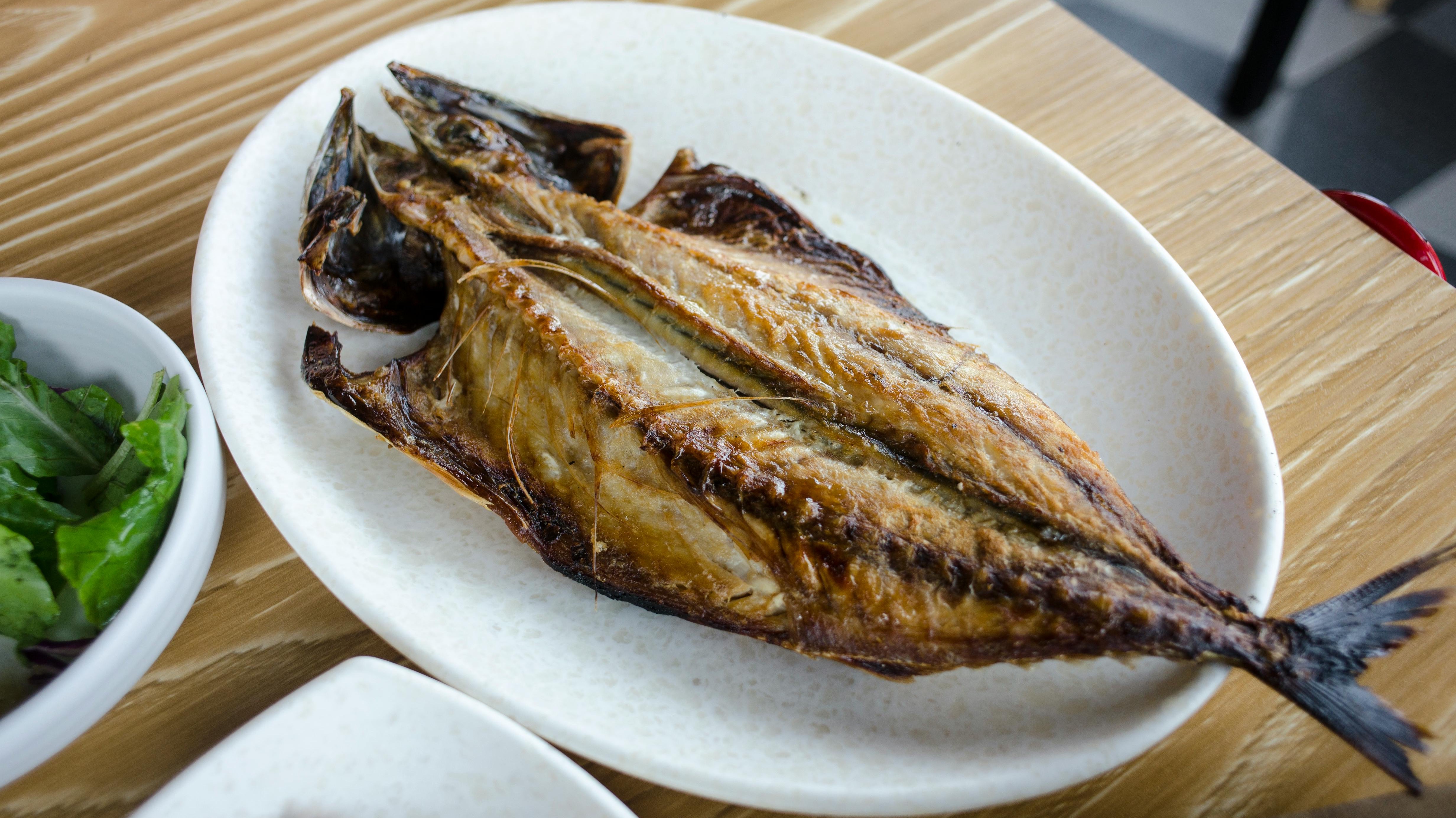 Omaha fish fry season dining scene with hands using forks.