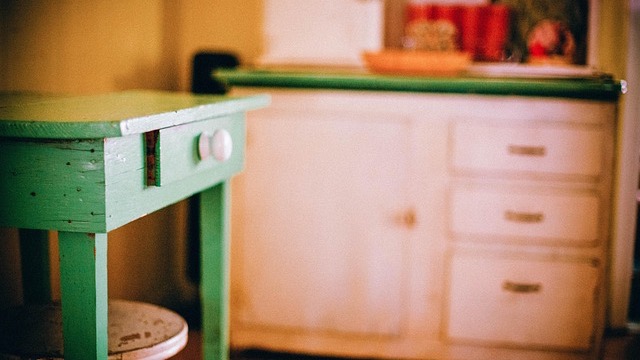 Mobile miter saw station with ample storage and caster wheels in a workshop.