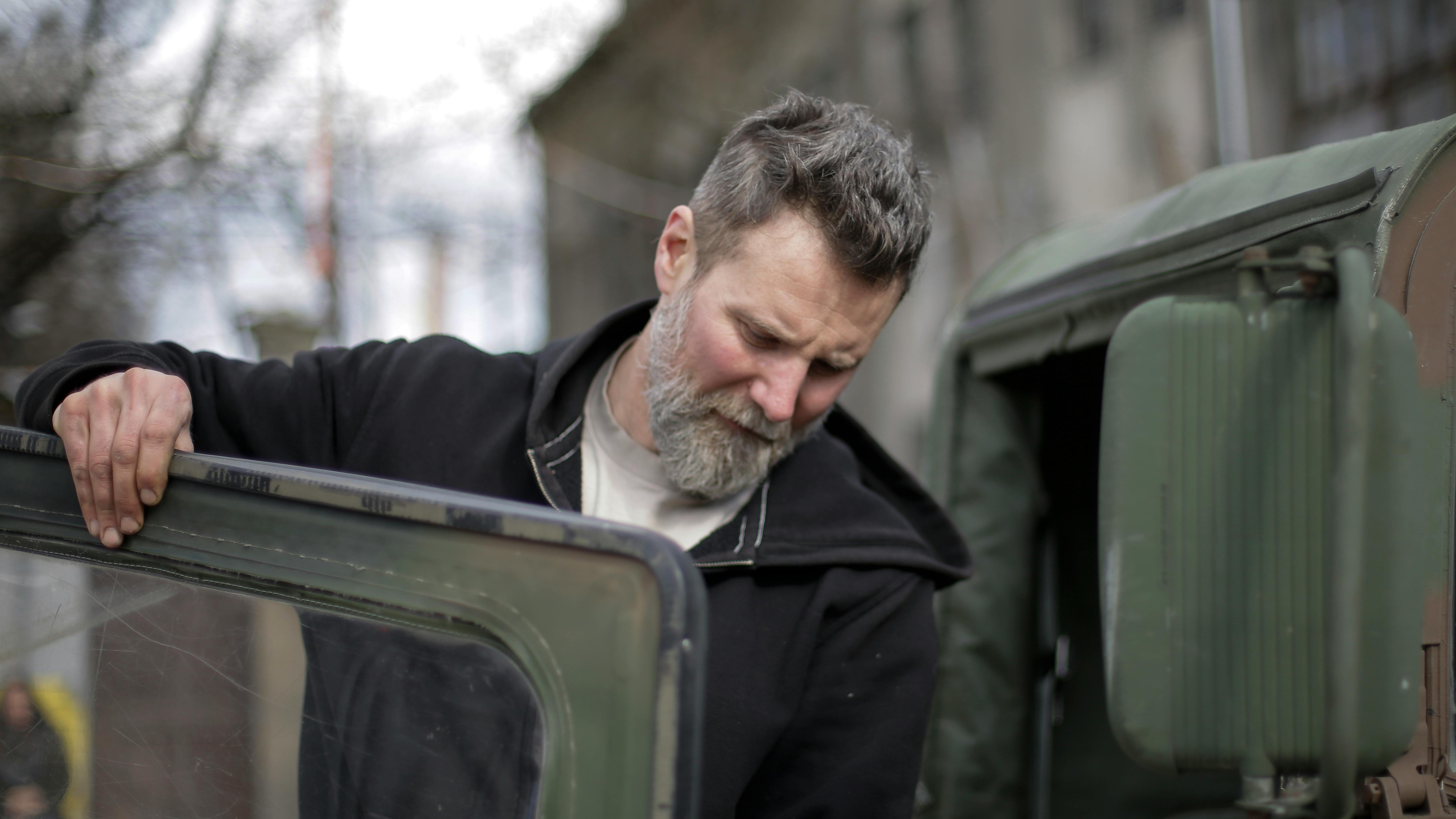 Two men discussing transition from active duty to civilian in sunlit room.