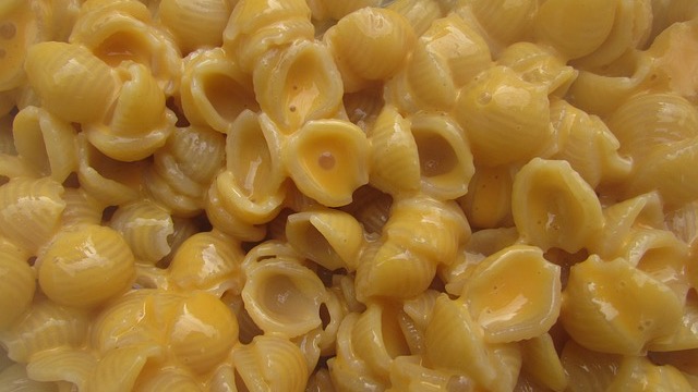 Simple mac and cheese in two bowls on a marble surface.