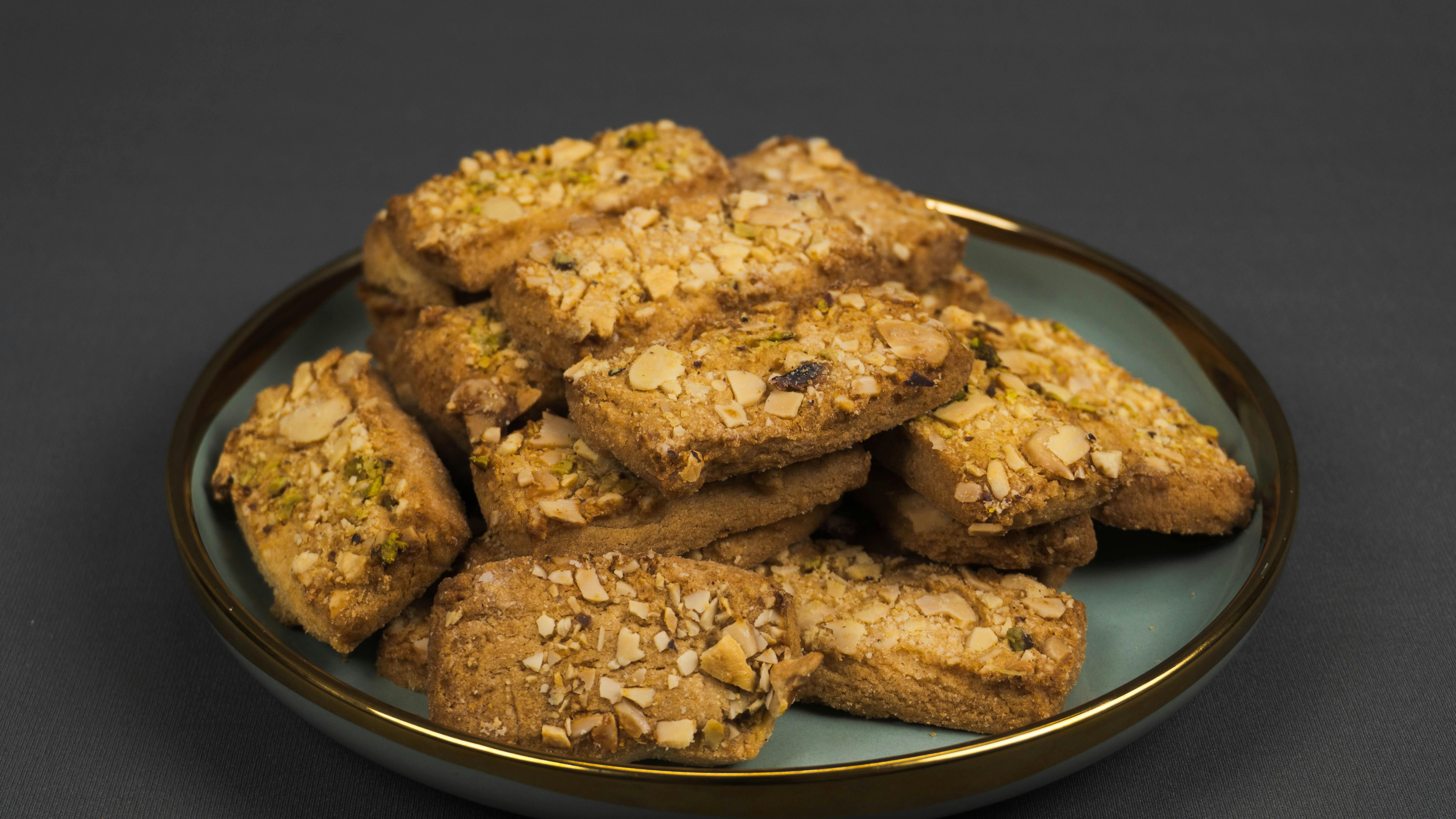 4 Ingredient Almond Joy Cookies preparation with baked cookies on plate.