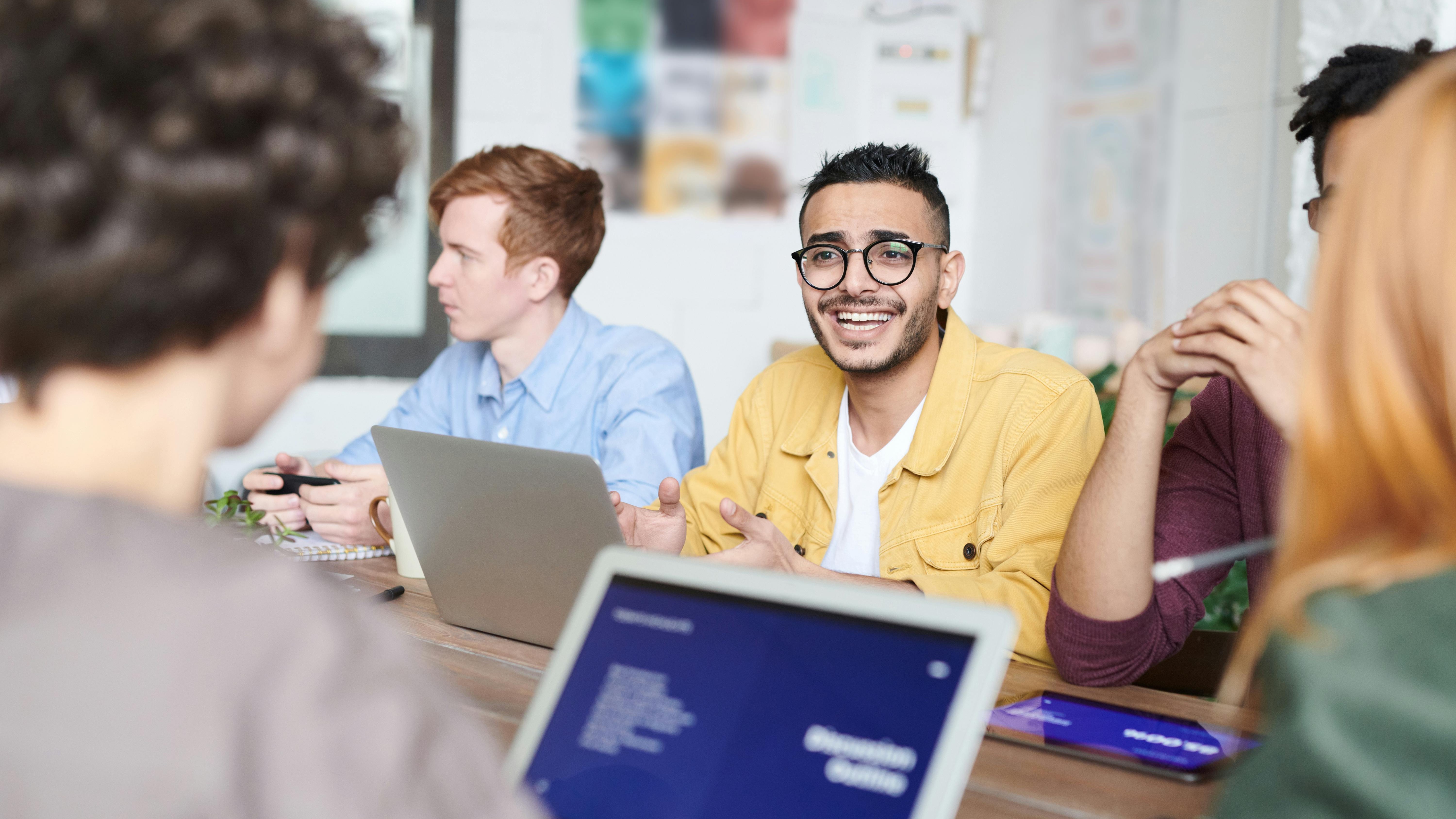 Diverse professionals in a bright office, fostering psychological safety and collaboration.