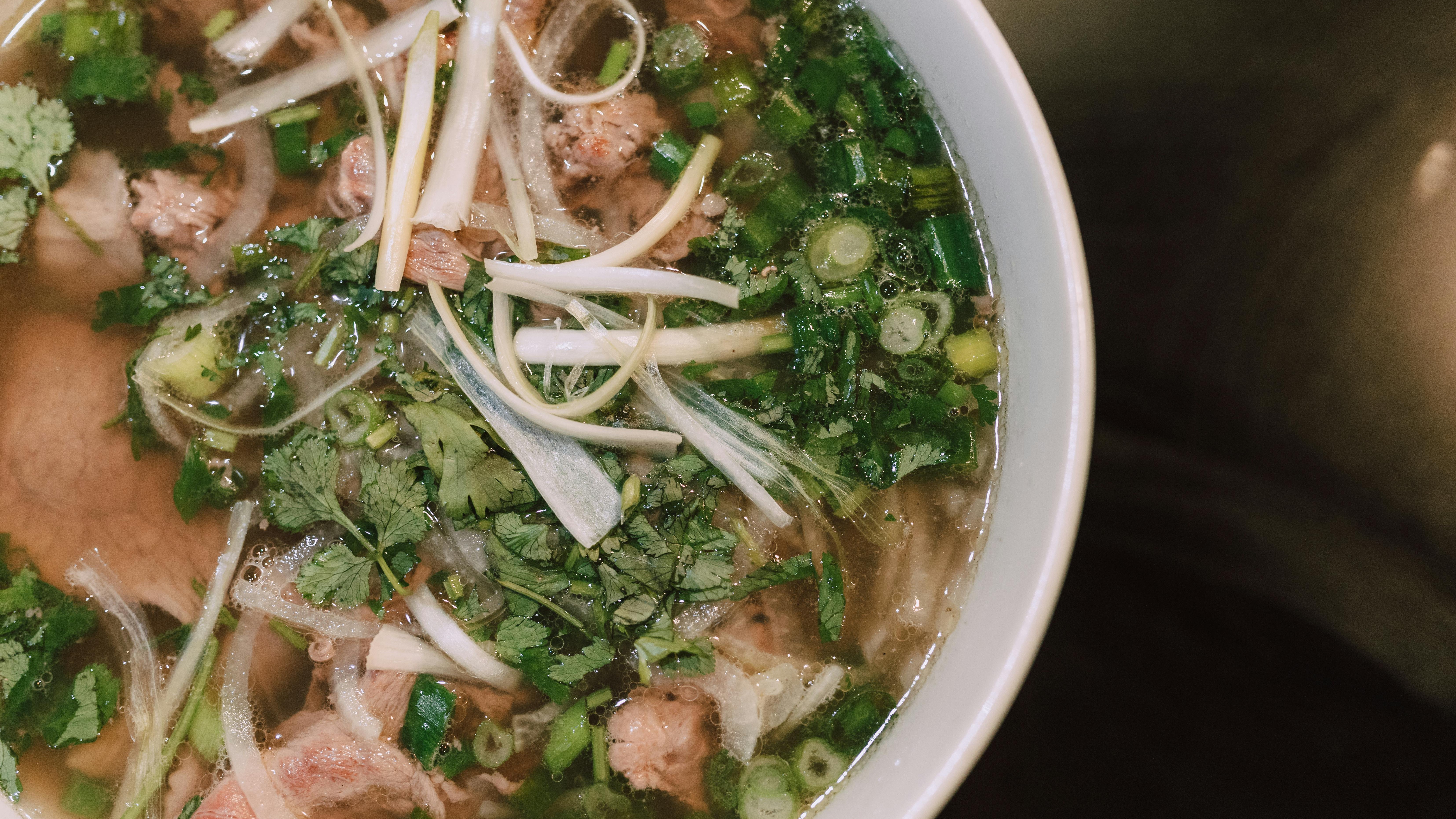 Delicious vegetable noodle soup with peas and cheese.