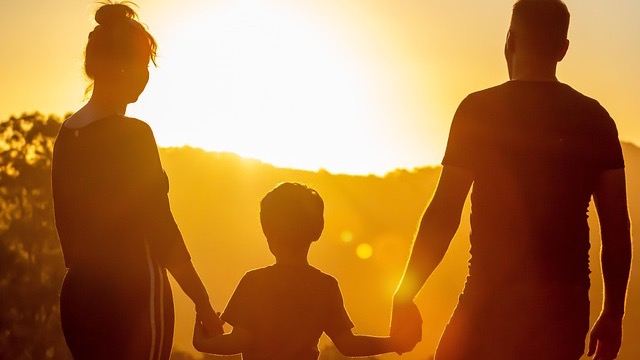 Father assisting teenage son with homework showing lawnmower parenting consequences