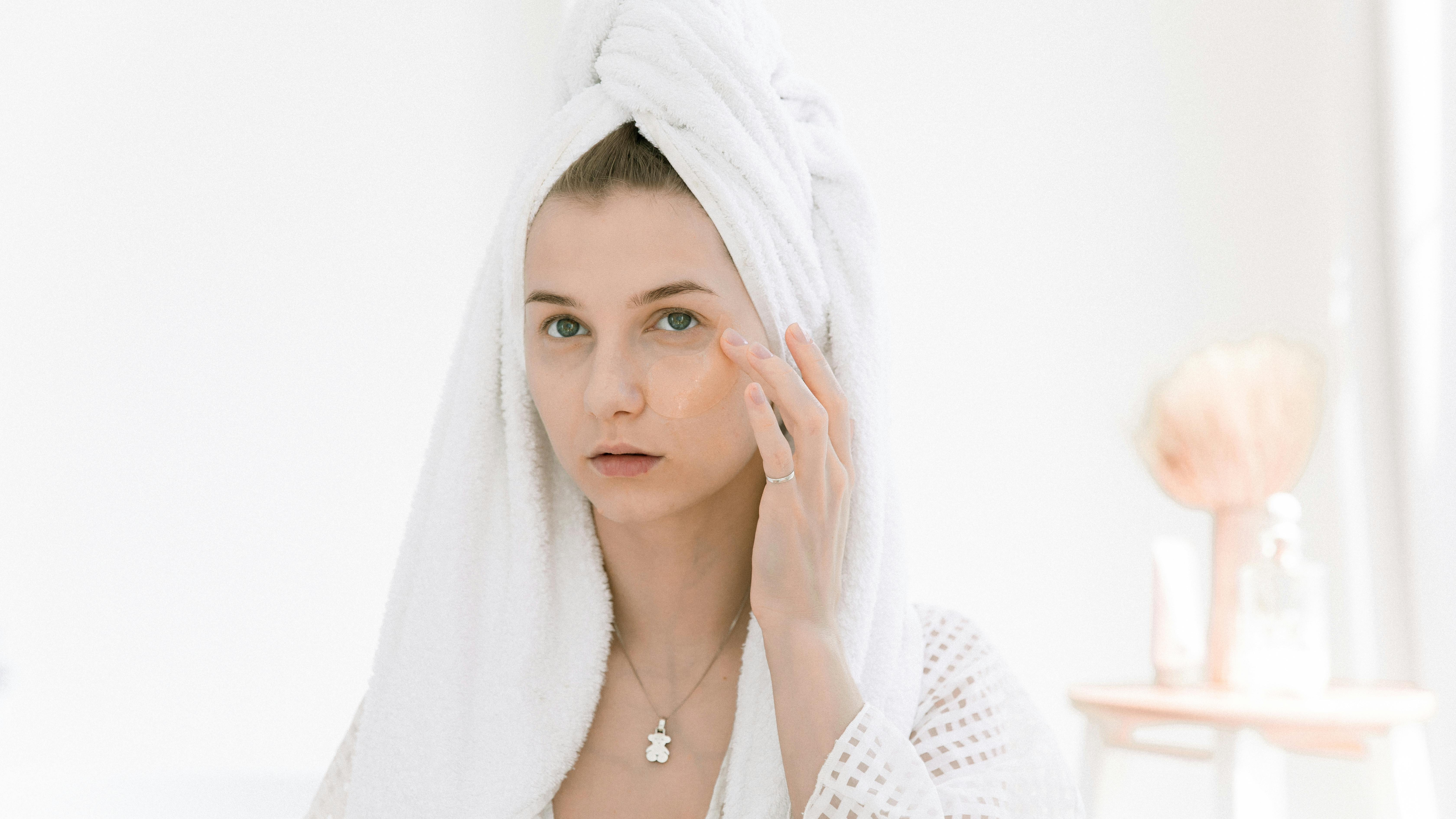 Pregnant woman practicing pregnancy-safe skincare in a modern bathroom.